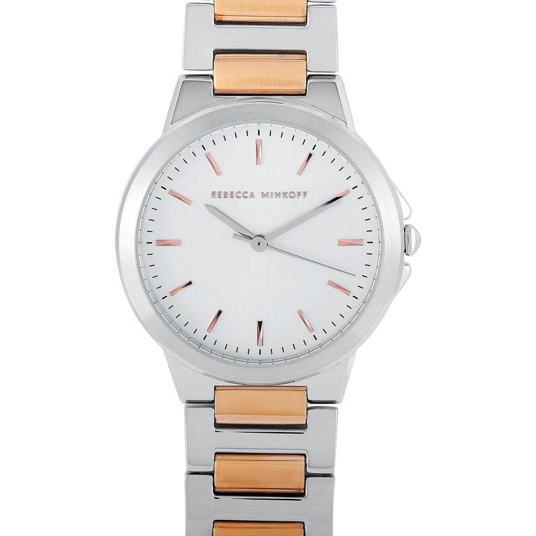 This is the Rebecca Minkoff Cali, reference number 2200324. The watch is presented with a silver-tone stainless steel case that measures 34 mm in diameter. The case is water-resistant to 30 meters and mounted onto a two-tone stainless steel