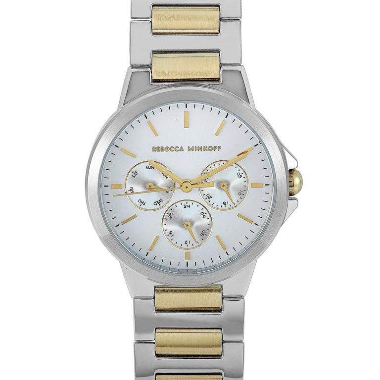 This is the Rebecca Minkoff Cali, reference number 2200358. The watch is presented with a stainless steel case that measures 36 mm in diameter. The case is water-resistant to 30 meters and mounted onto a two-tone stainless steel bracelet. This model