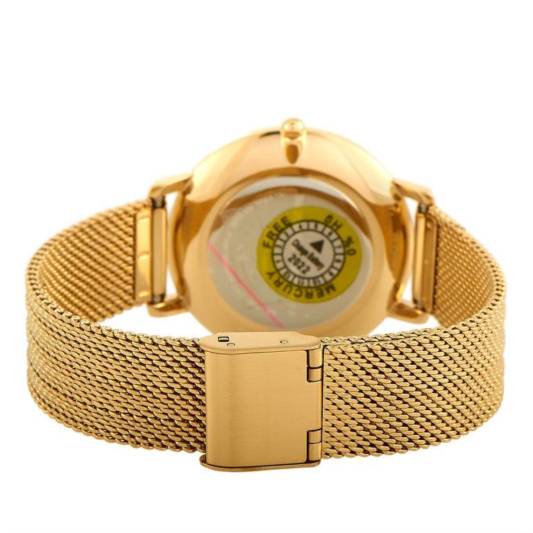 This is the Rebecca Minkoff Major watch, reference number 2200346. It is presented with a gold-tone stainless steel case that is mounted onto a matching gold-tone stainless steel mesh bracelet, secured on the wrist with a fold over clasp. The case