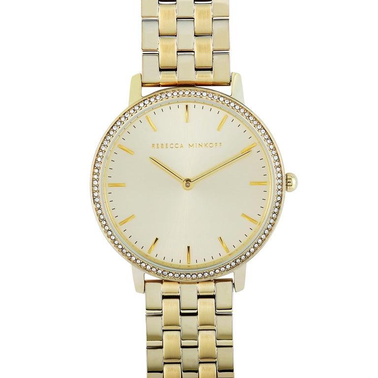 This is the Rebecca Minkoff Major, reference number 2200348. The watch boasts a 35 mm gold-tone stainless steel case that is embellished with crystals. The case is water-resistant to 30 meters and mounted onto a gold-tone stainless steel bracelet.