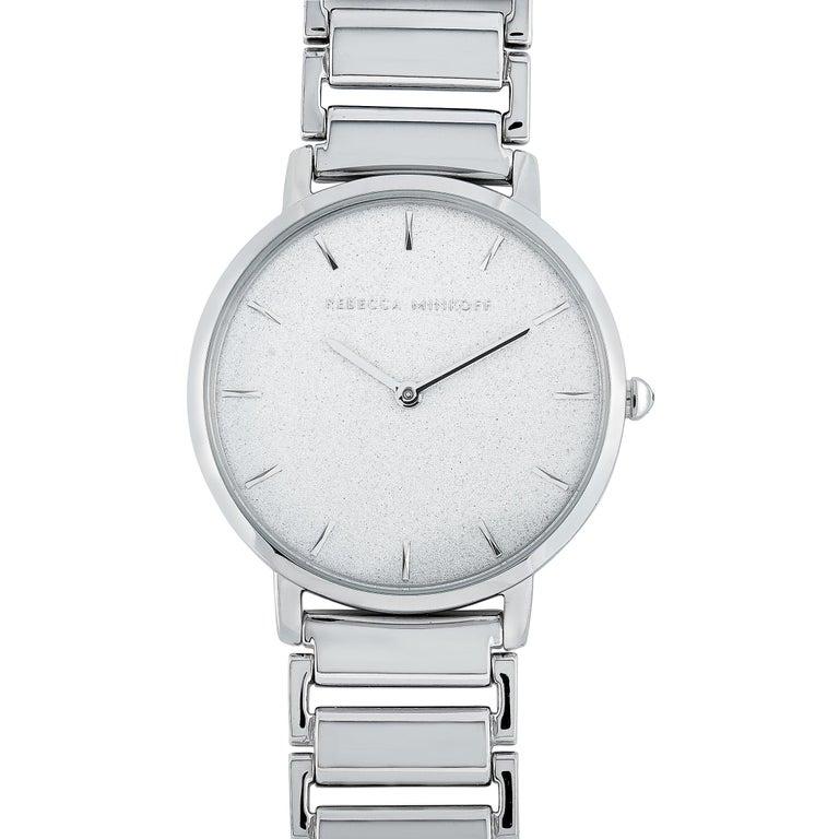 This is the Rebecca Minkoff Major watch, reference number 2200258. It boasts a 35 mm silver-tone stainless steel case that is water-resistant to 30 meters. The case is presented on a matching silver-tone stainless steel bracelet. This model is
