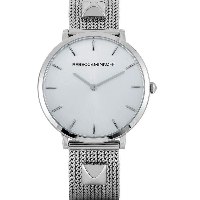 This is the Rebecca Minkoff Major, reference number 2200001. The watch boasts a 35 mm stainless steel case that is water-resistant to 30 meters. The case is presented on a stainless steel mesh bracelet with stud details, secured on the wrist with a