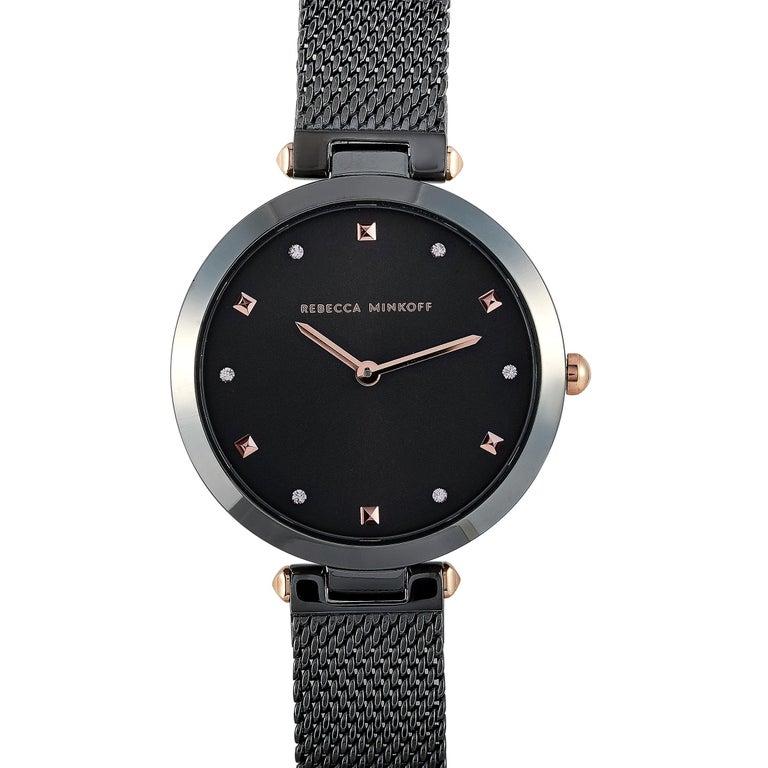 This is the Rebecca Minkoff Nina watch, reference number 2200302. It is presented with a 33 mm gunmetal gray ion-plated stainless steel case that is water-resistant to 30 meters. The case is mounted onto a gunmetal gray ion-plated stainless steel