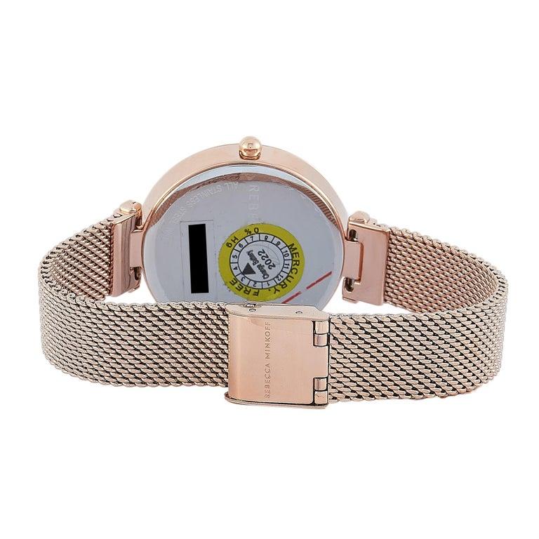 This is the Rebecca Minkoff Nina watch, reference number 2200301. It is presented with a rose gold ion-plated stainless steel case that is mounted onto a matching rose gold-tone stainless steel mesh bracelet. The case measures 33 mm in diameter and