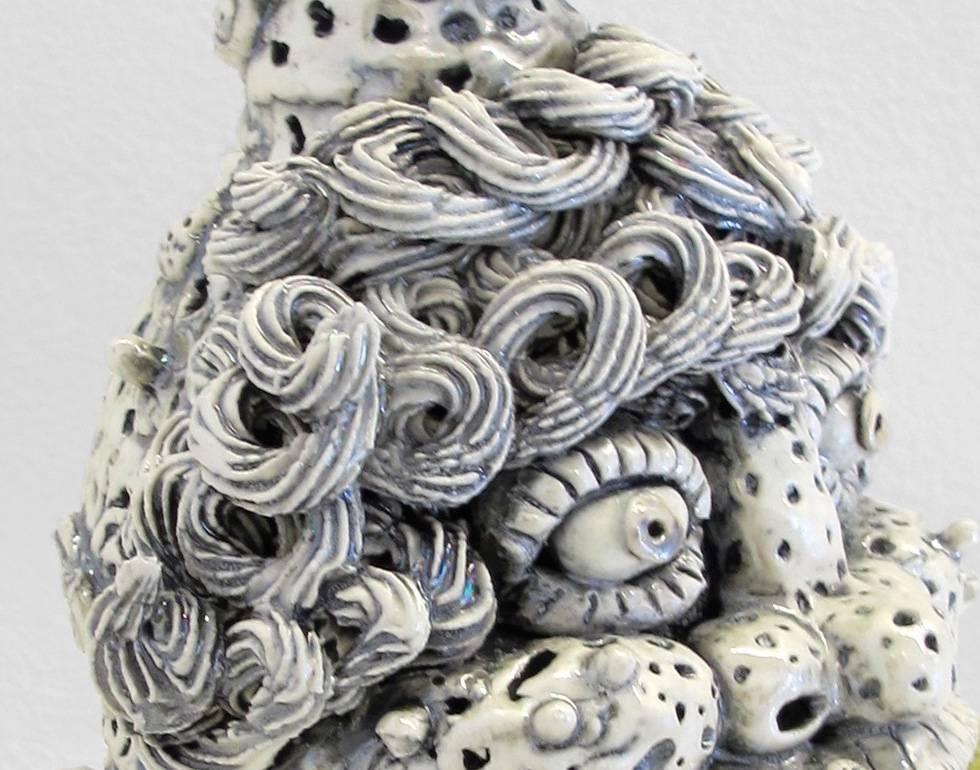 This playful gray jug was created with porcelain.

Rebecca Morgan is from central Pennsylvania, and her paintings, drawings, and ceramics emanate from stereotypes of rural Appalachia. Humorous, benevolent, and savage at turns, her characters touch