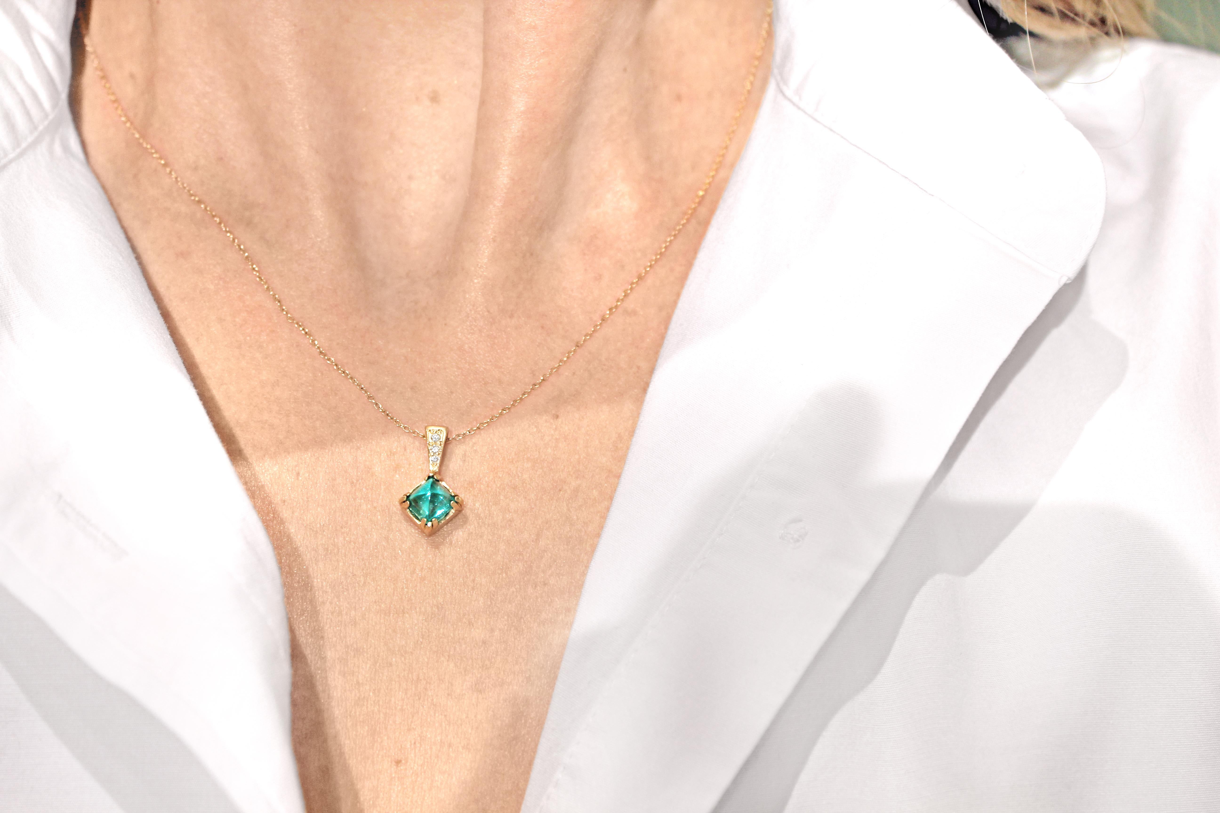 One-of-a-Kind Vintage Emerald Necklace handcrafted in matte-finished 14k yellow gold showcasing a spectacular bluish-green completely natural and unheated 1.37 carat vintage sugarloaf emerald accented with a 0.025 total carats of round brilliant-cut