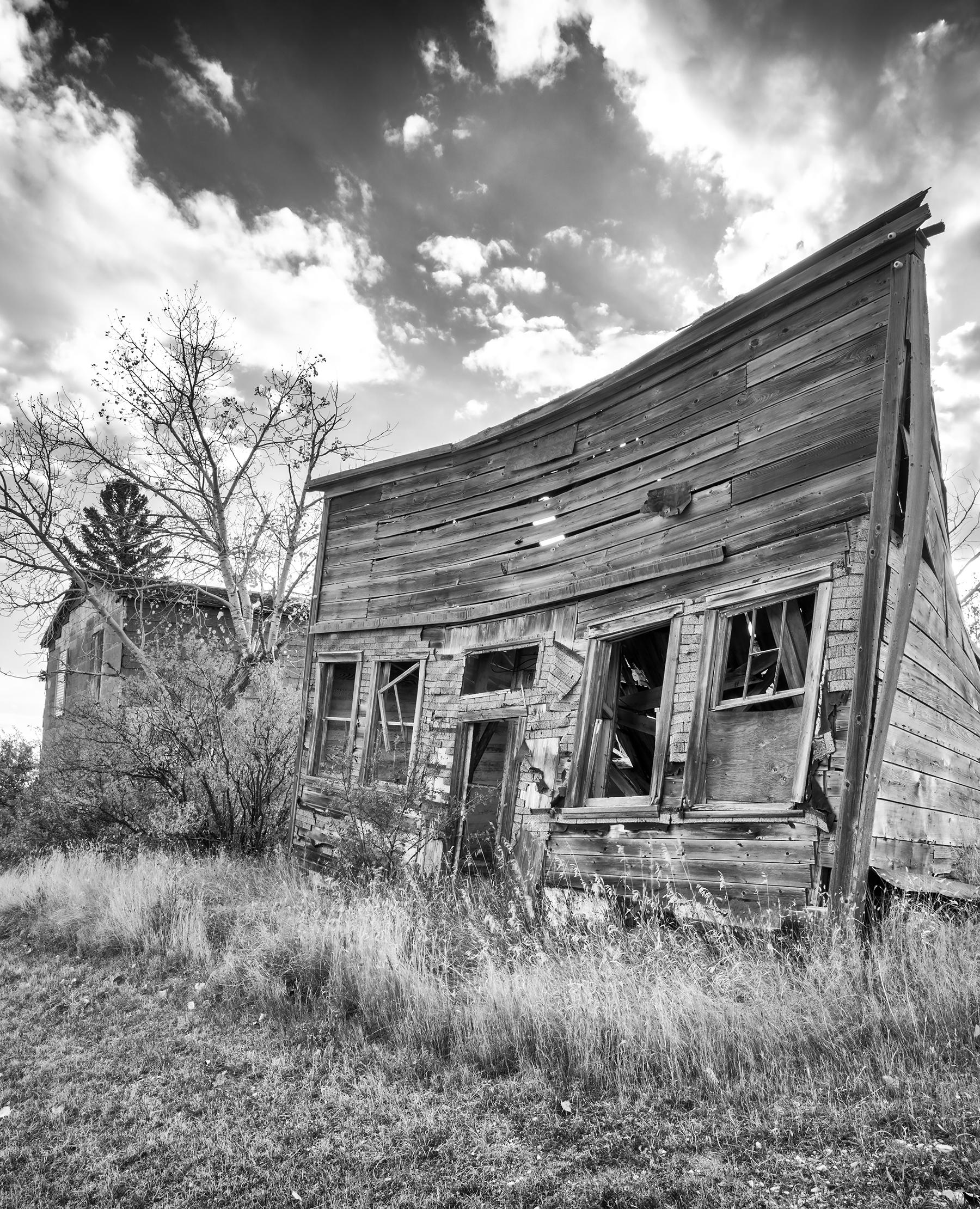 Rebecca Skinner’s “Alkabo I” is a 24 x 36 inch black and white photograph captured in a North Dakota ghost town. Dramatic sky frames a weathered structure in this beautiful contemporary landscape. The frameless metal print has a satin finish and is