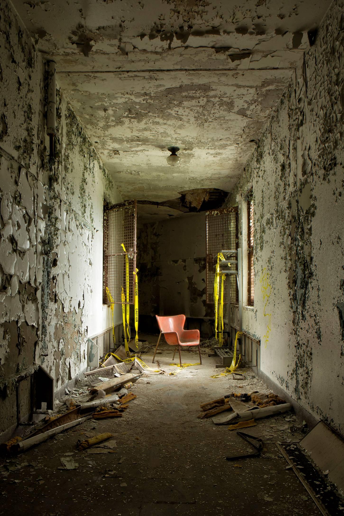 Rebecca Skinner Still-Life Photograph - "Empty", contemporary, abandoned, hallway, chair, orange, color photo, print