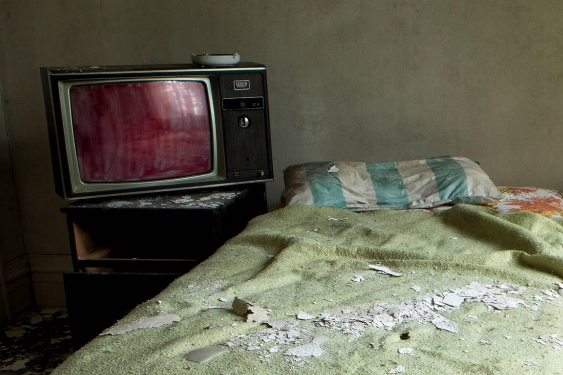 Rebecca Skinner’s “Exhausted” is a 11 x 17 inch metal print and is part of her “Transient” series. The color photograph of a bedroom in an abandoned home gives the viewer a sense of place and time. The frameless print has a satin finish and is