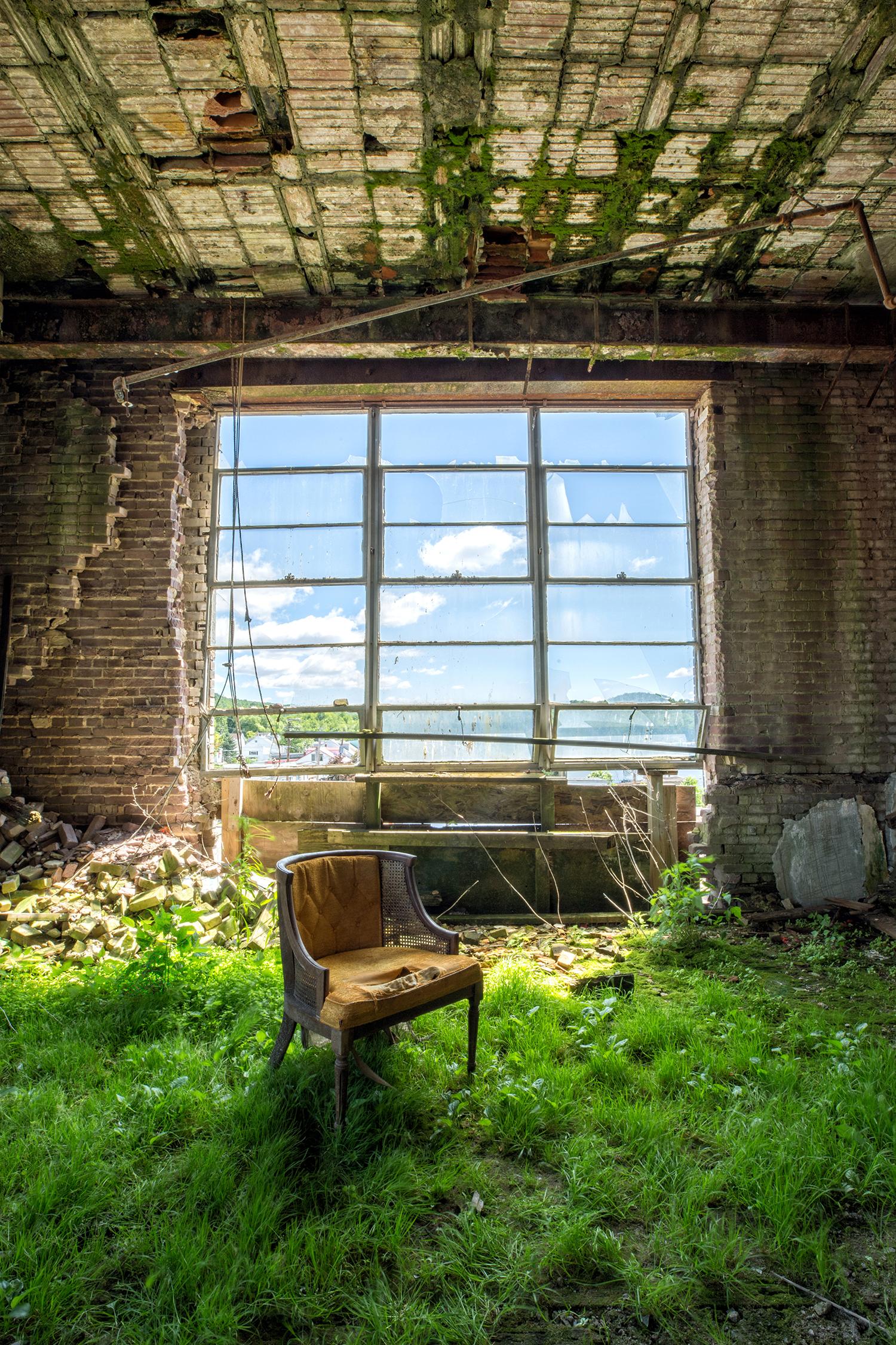 Rebecca Skinner Color Photograph - "Exist", contemporary, interior, chair, grass, brick, window, green, photograph