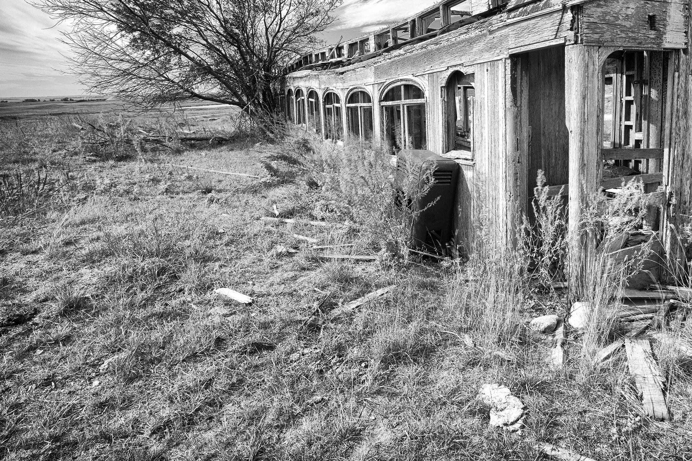 Rebecca Skinner’s “Great Norther Railcar” is a 16 x 24 inch contemporary black and white photograph of a weathered railcar resting in the beautiful North Dakota landscape. The frameless metal print has a satin finish and is infused directly into