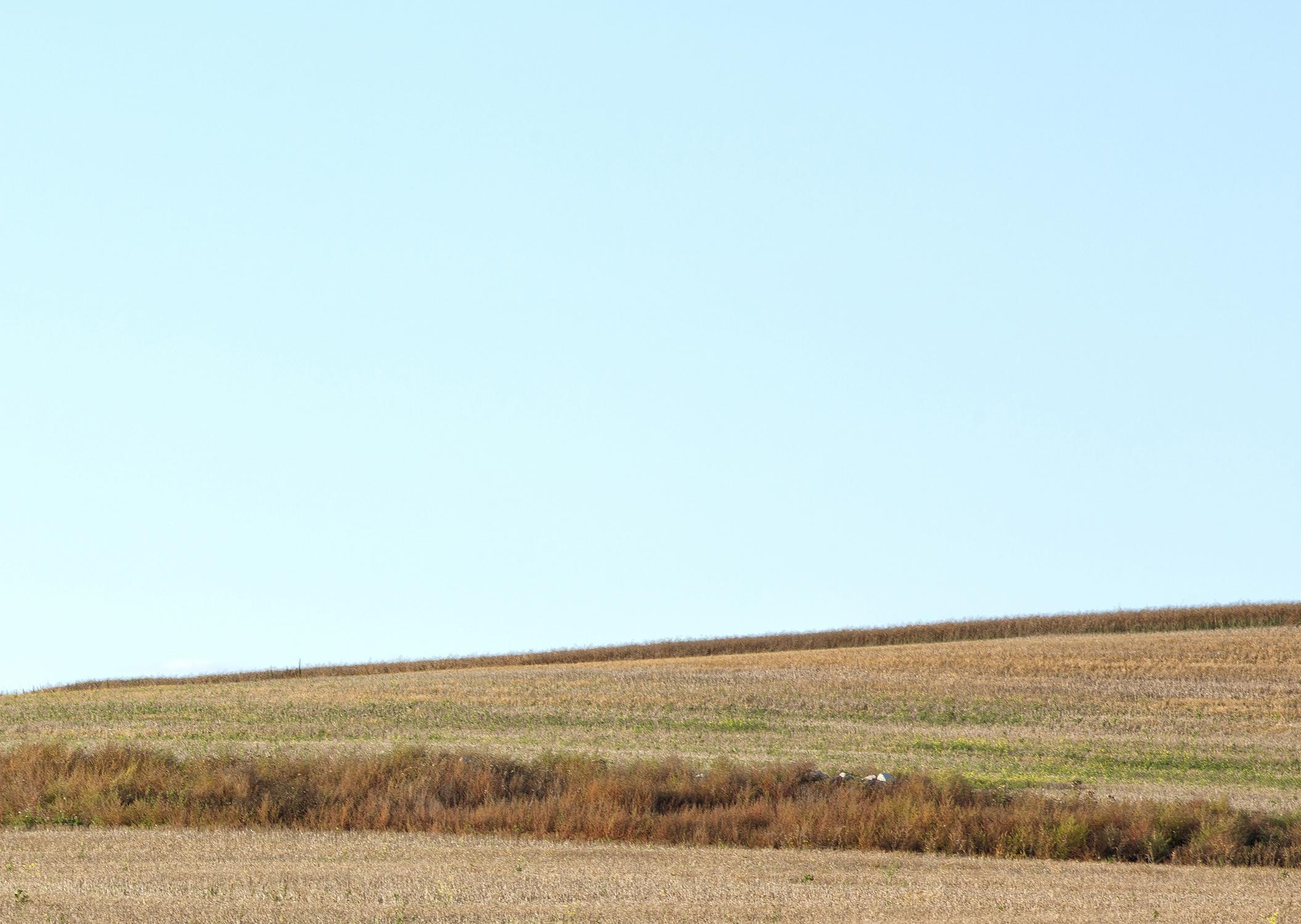 Rebecca Skinner’s “Saint Olaf Church” is a 24 x 36 inch color photograph captured in the North Dakota grasslands. The historic structure rests in the beautiful landscape with colors of blue, yellow, brown and green. The frameless metal print has a