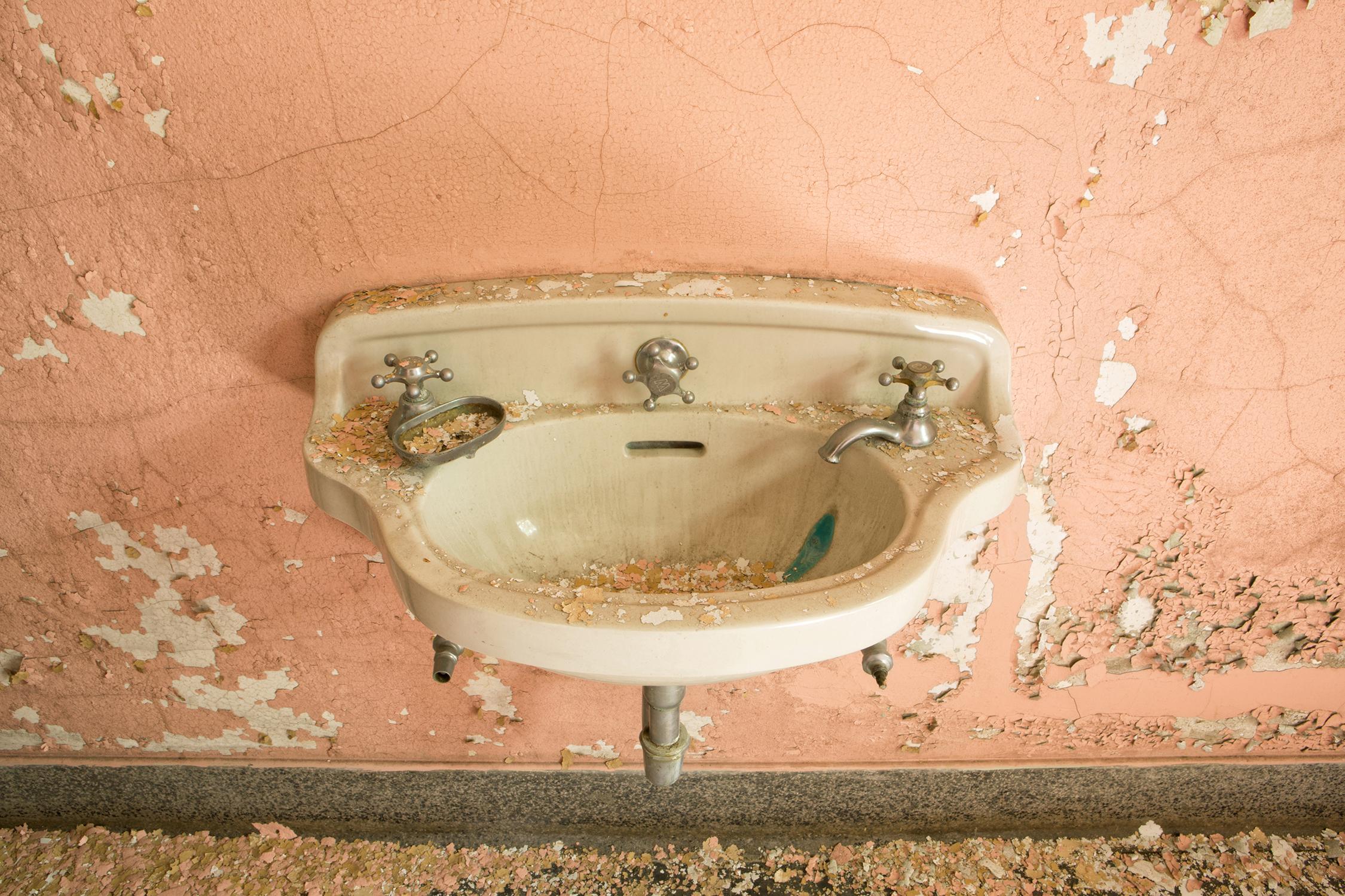 Rebecca Skinner’s “Sink I - VI” is a hexaptych made up of six 8 x 12 inch metal prints photographed at an abandoned hospital. The color photographs are of similar sinks against different colored walls of pink, beige, yellow, green and blue with