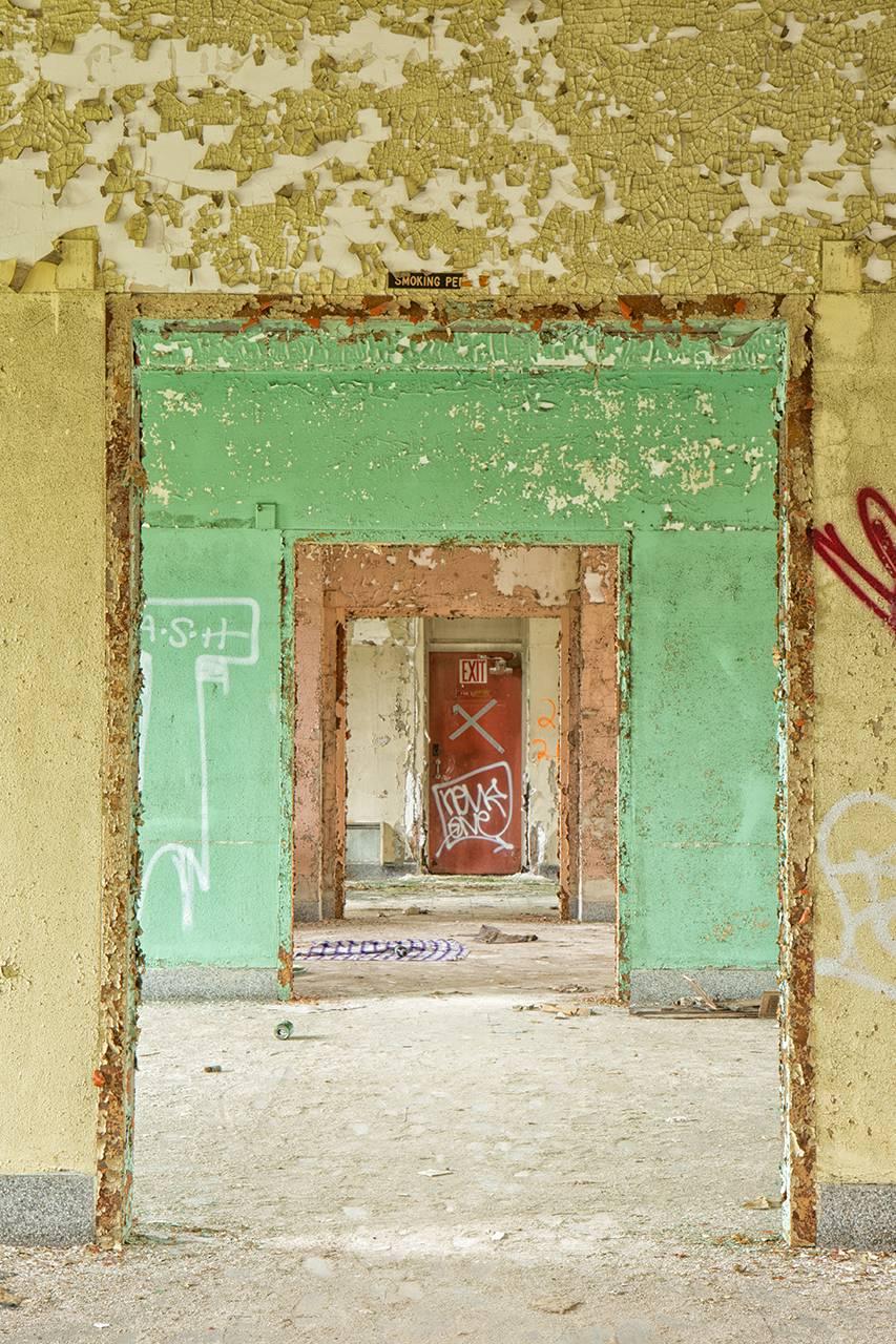 "Succession", contemporary, abandoned, doorways, interior, red, color photo - Photograph by Rebecca Skinner