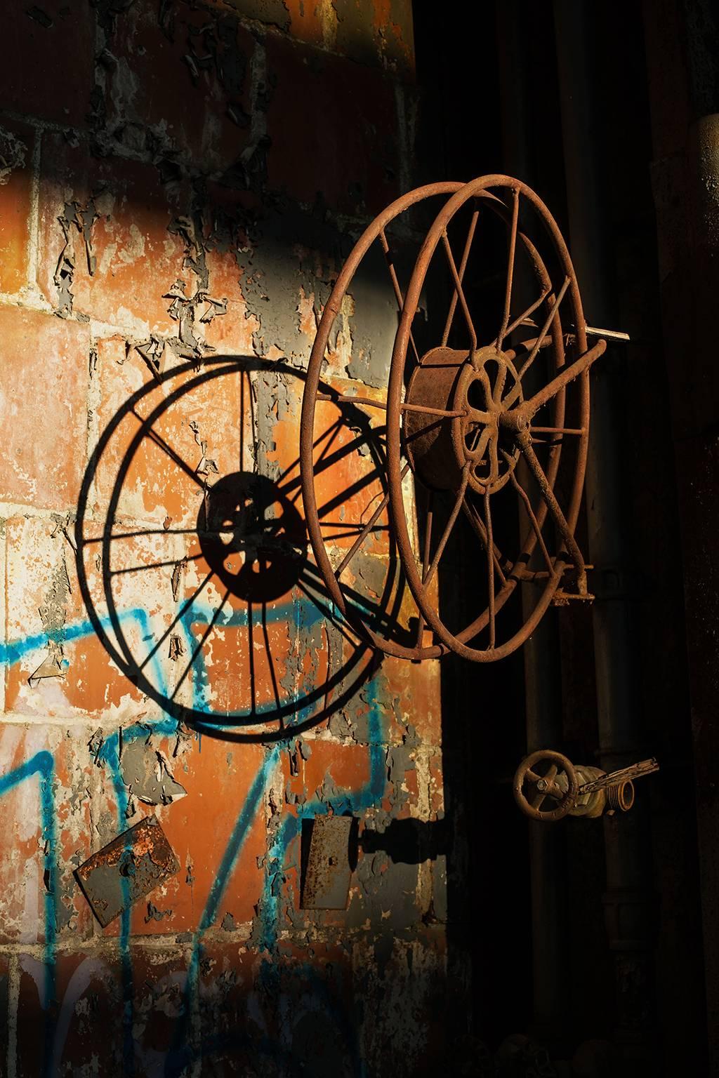 "Unaccompanied", industrial, abandoned, hose reel, shadows, orange, color photo