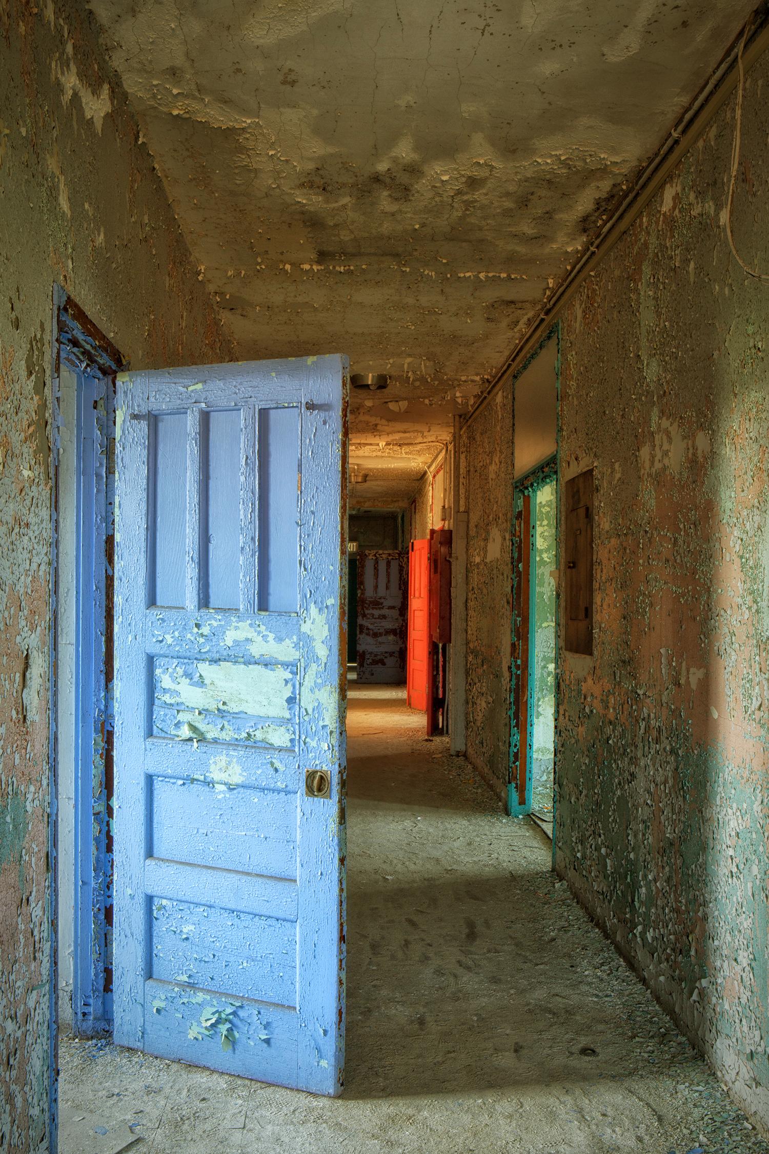 Rebecca Skinner Still-Life Photograph - "West Hallway", color photo, abandoned, metal print, door, blue, red, purple