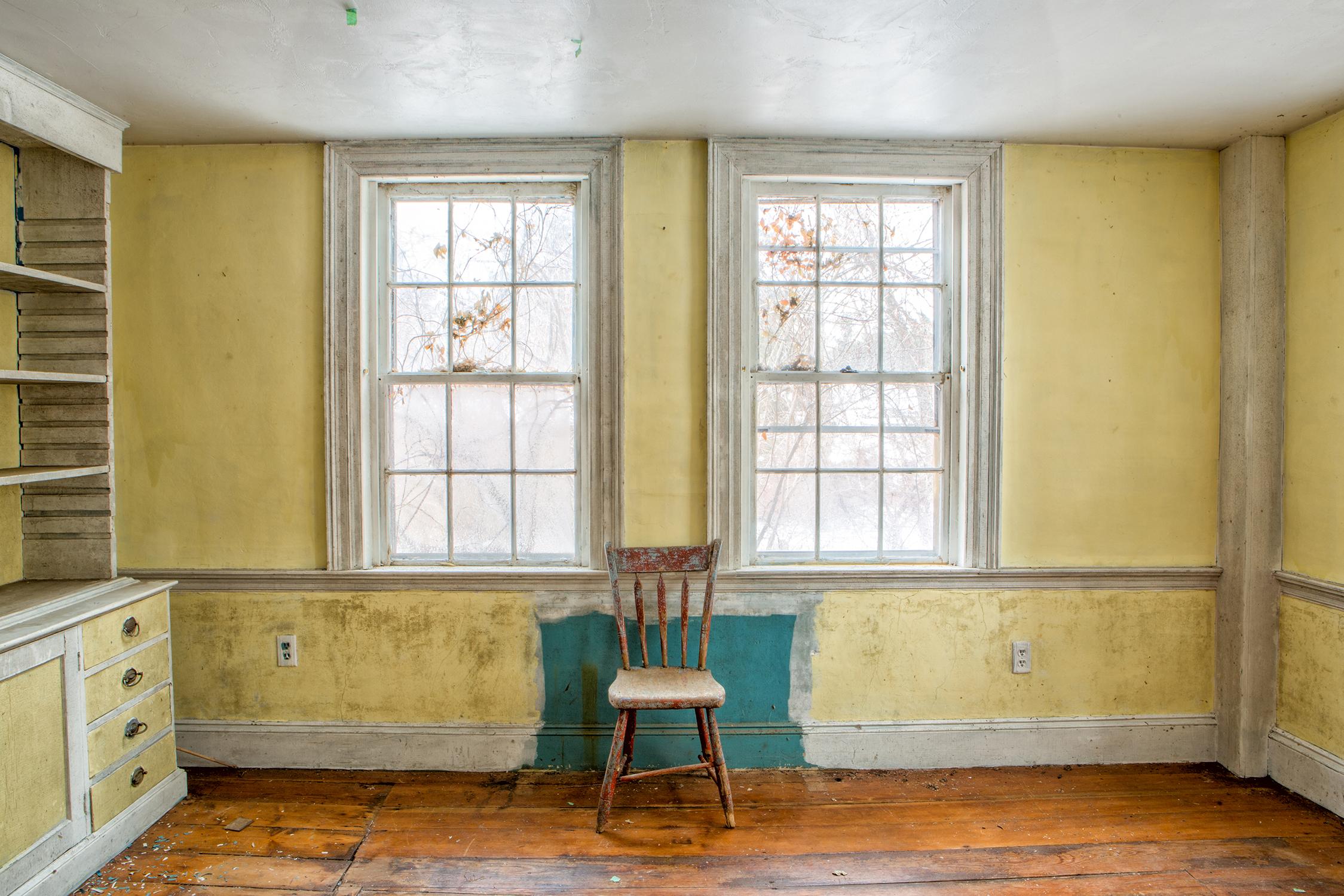 Rebecca Skinner Still-Life Photograph - "Yellow Room", contemporary, abandoned farmhouse, chair, blue, color photograph
