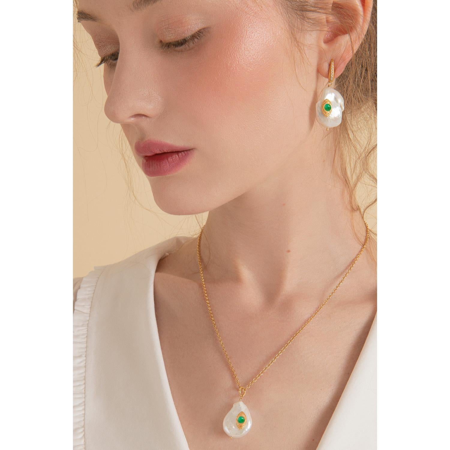 'The Eye' pendants by Vintouch are handcrafted in Italy from 18-karat gold-plated silver featuring vivid green emeralds. The dainty pearl is handset with a 18-karat gold-plated silver eye-looking element inspired by Egyptian Eye of Horus,