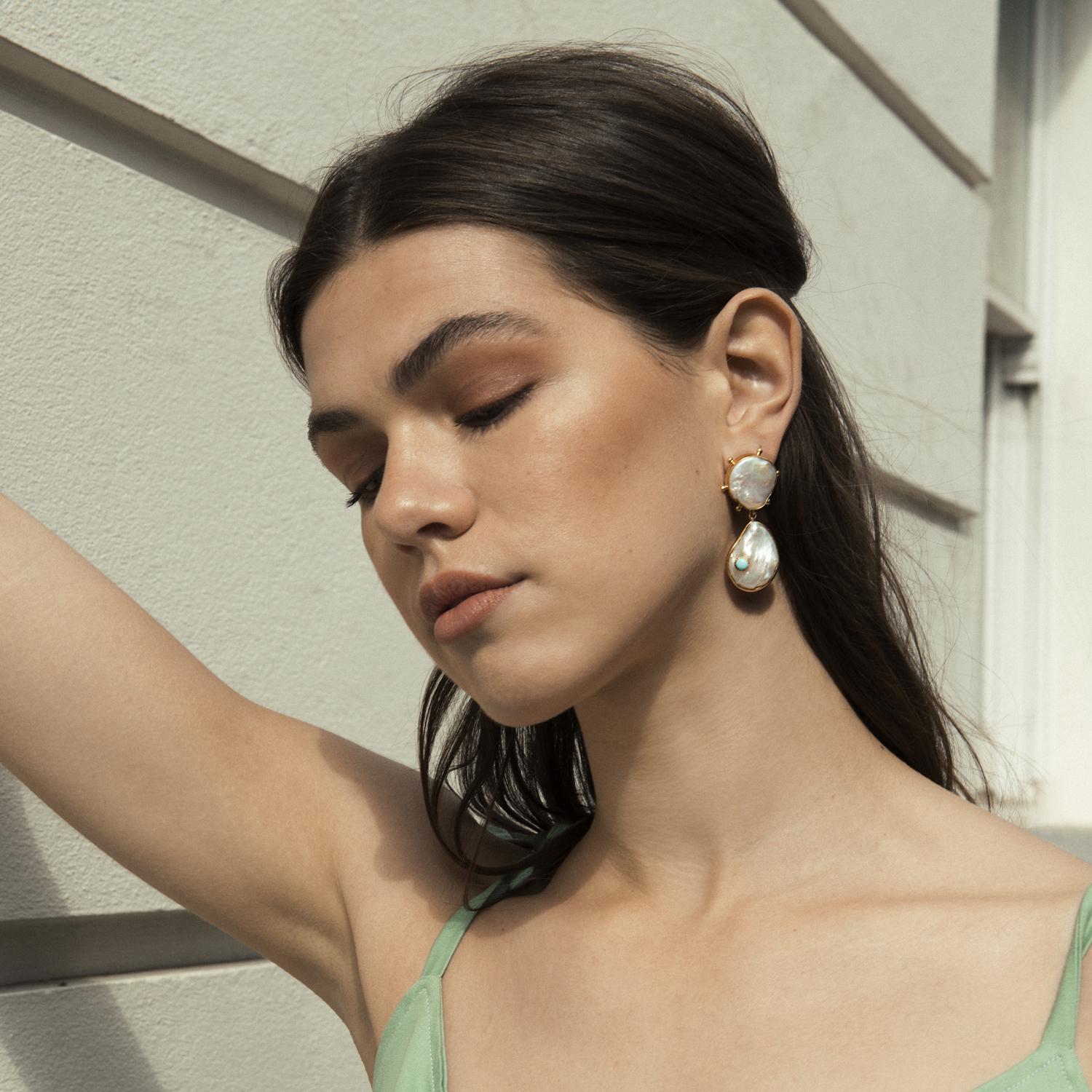 A celebration of beauty in its natural forms, the Rebel Rebel earrings by Vintouch are handmade from 18-karat gold-plated silver and each strung with glossy keshi and baroque pearls featuring studded settings inspired by the glam-rock style and two