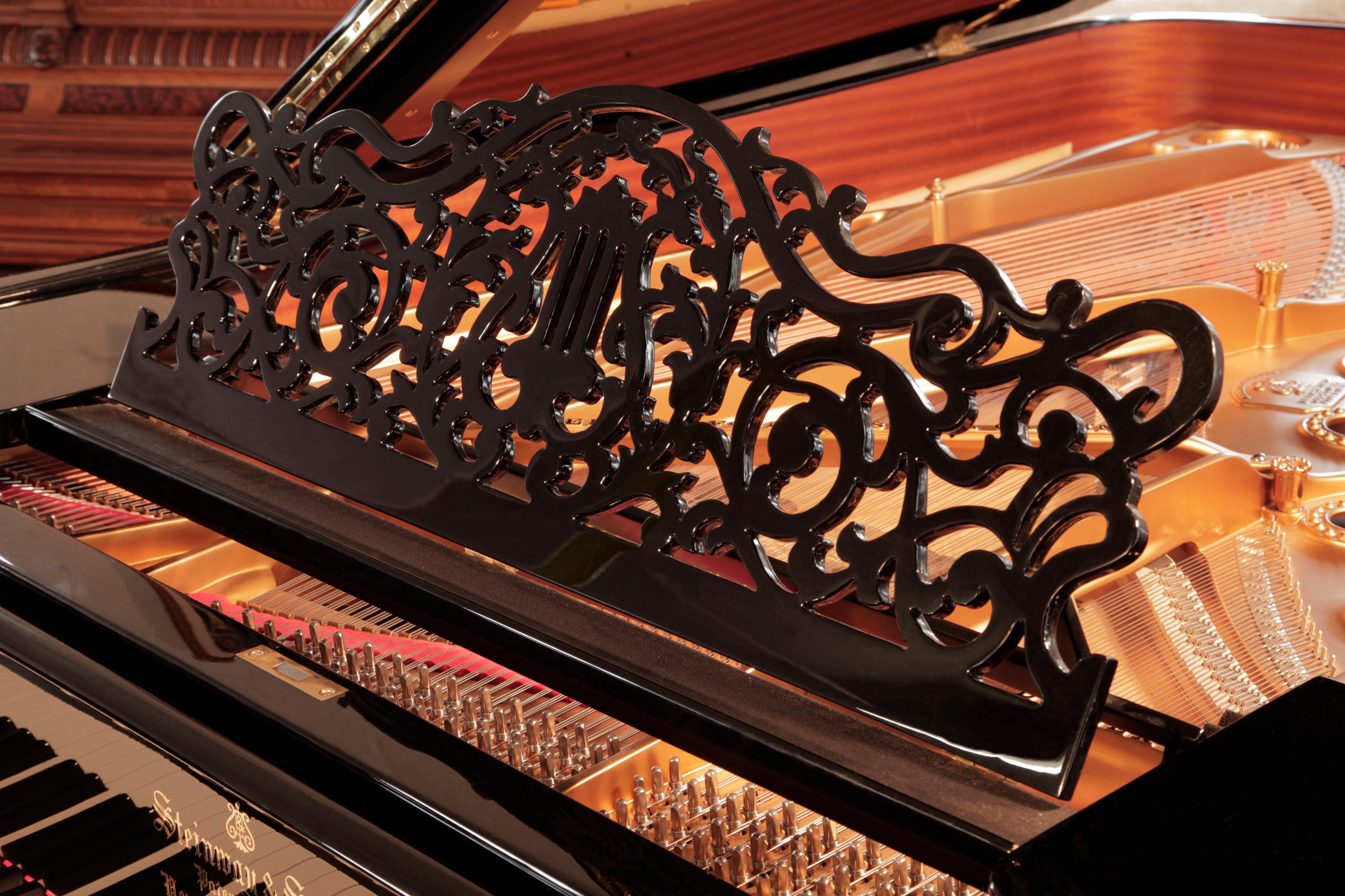 Rebuilt, 1886, Steinway Model B grand piano with a black case.
The music desk is in an openwork arabesque design featuring a central lyre motif 
surrounded by stylised tendrils and foliage. The serpentine piano cheek features a dual linear case