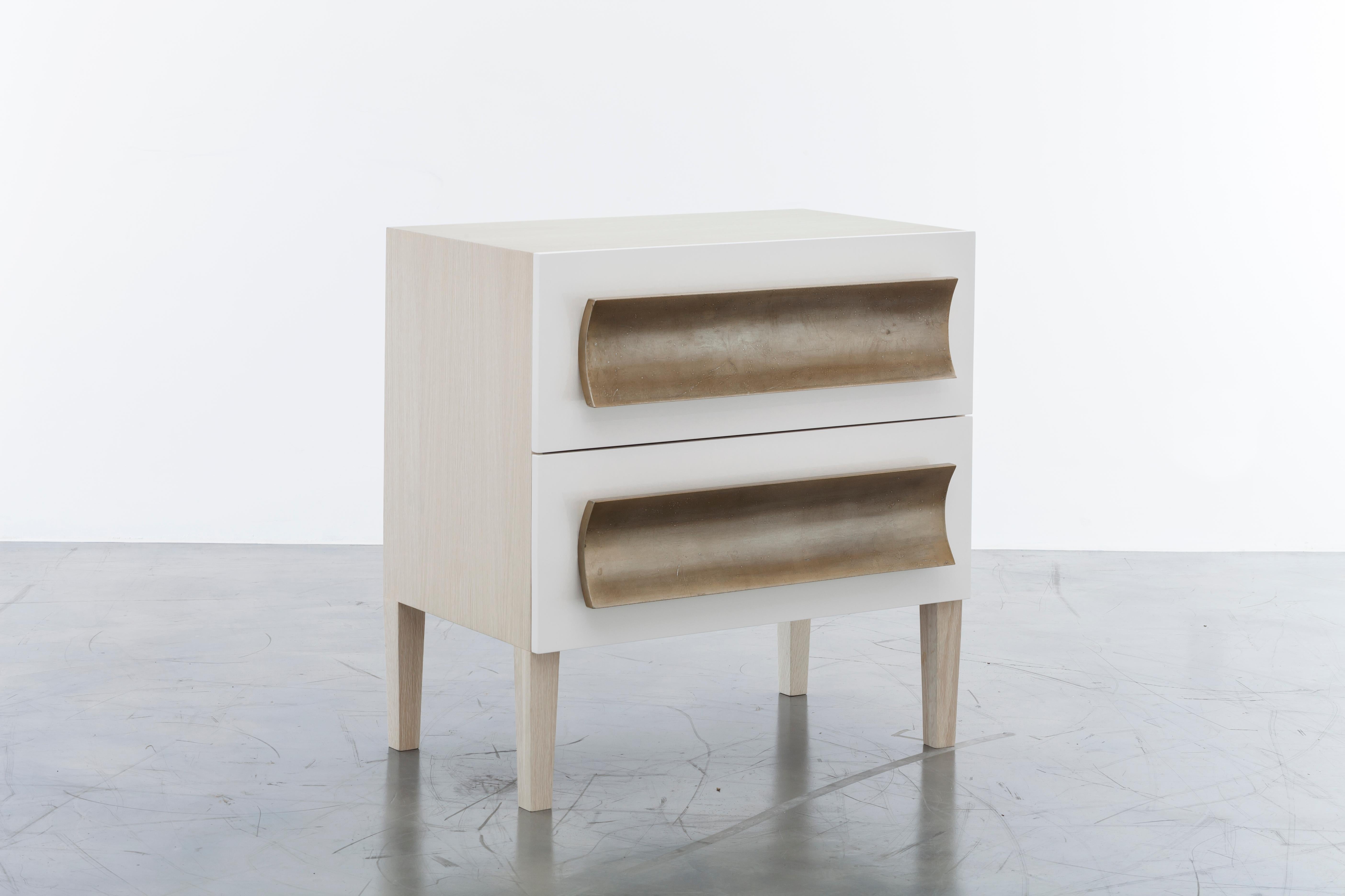 RECAMIER NIGHTSTAND - Modern Oak and Lacquer Body + Silver Leaf Hand-Carved Pull

The Recamier Nightstand is a beautifully designed piece of furniture that adds a touch of elegance and sophistication to any bedroom. The nightstand is crafted with an