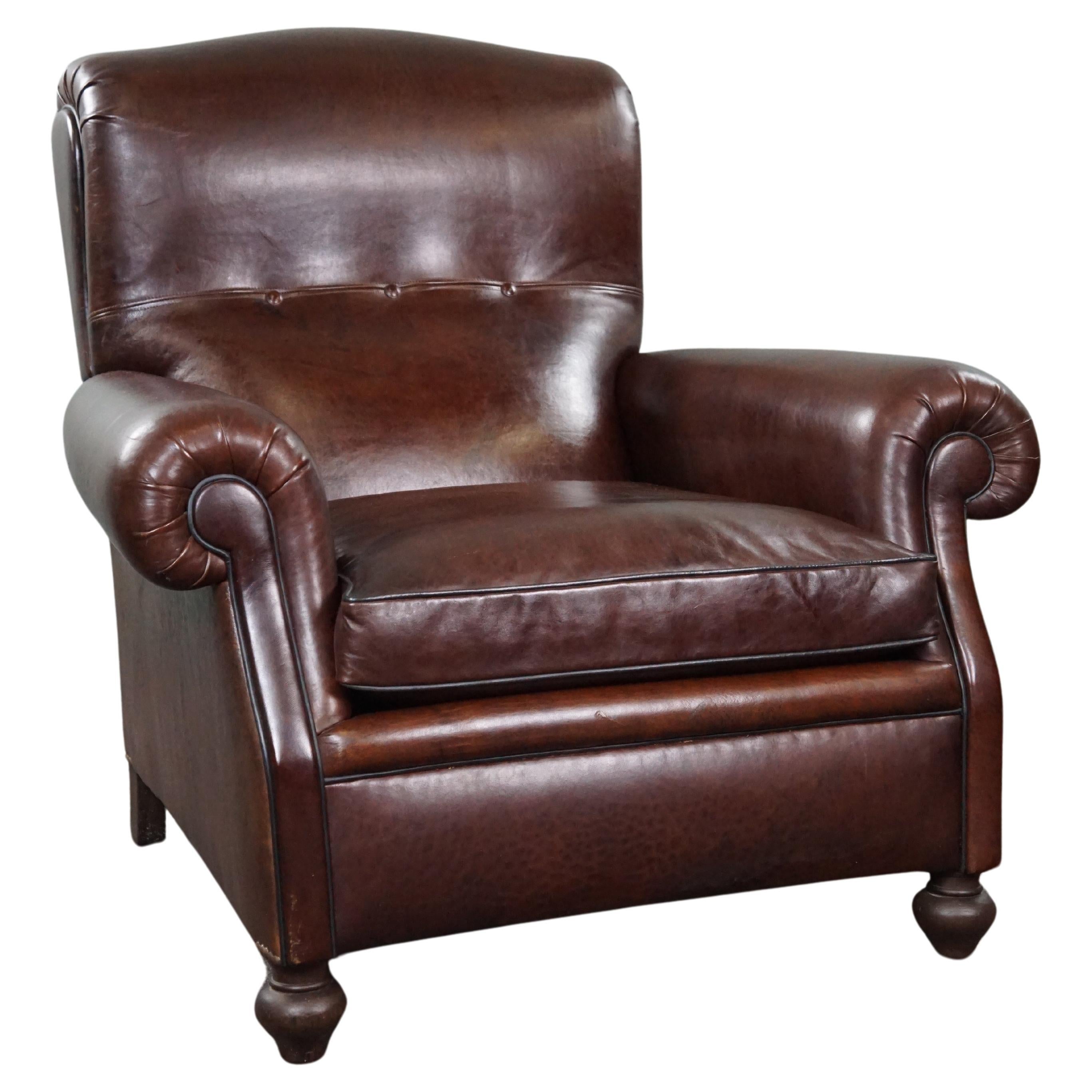 Recently reupholstered old English armchair in dark sheep leather color For Sale