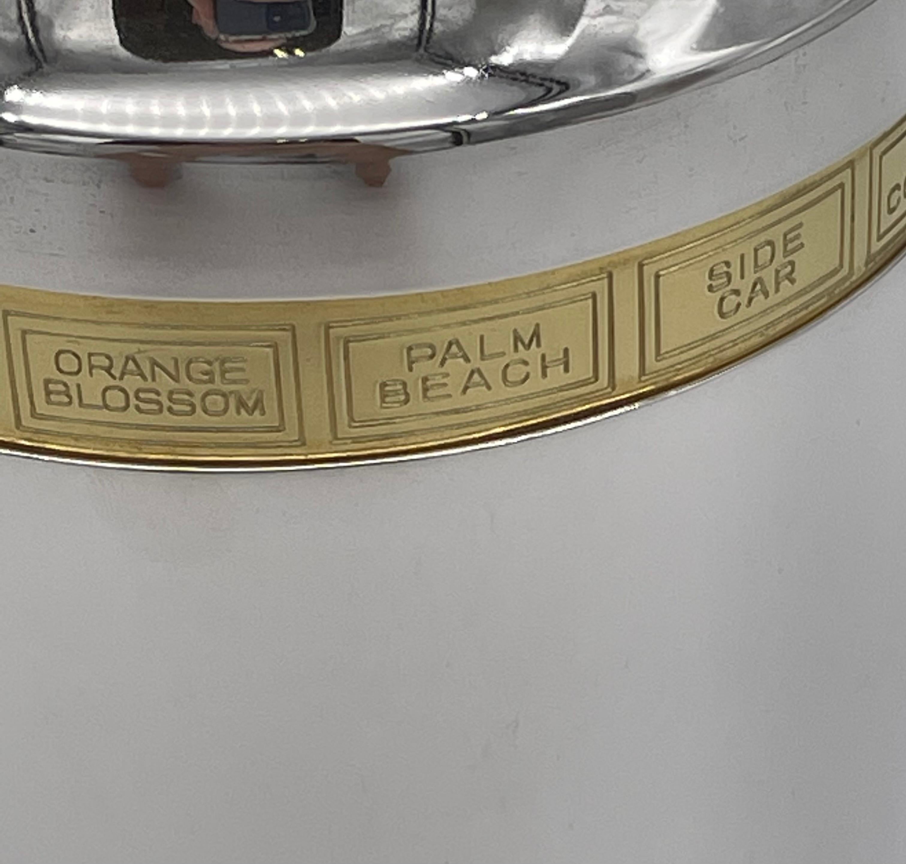 This is the classic silver-plated recipe cocktail shaker, first designed in the USA in 1933, and made in England from 1935.
The upper part of the shaker turns and an arrow points to one of many possible cocktails engraved on the inner rim. The