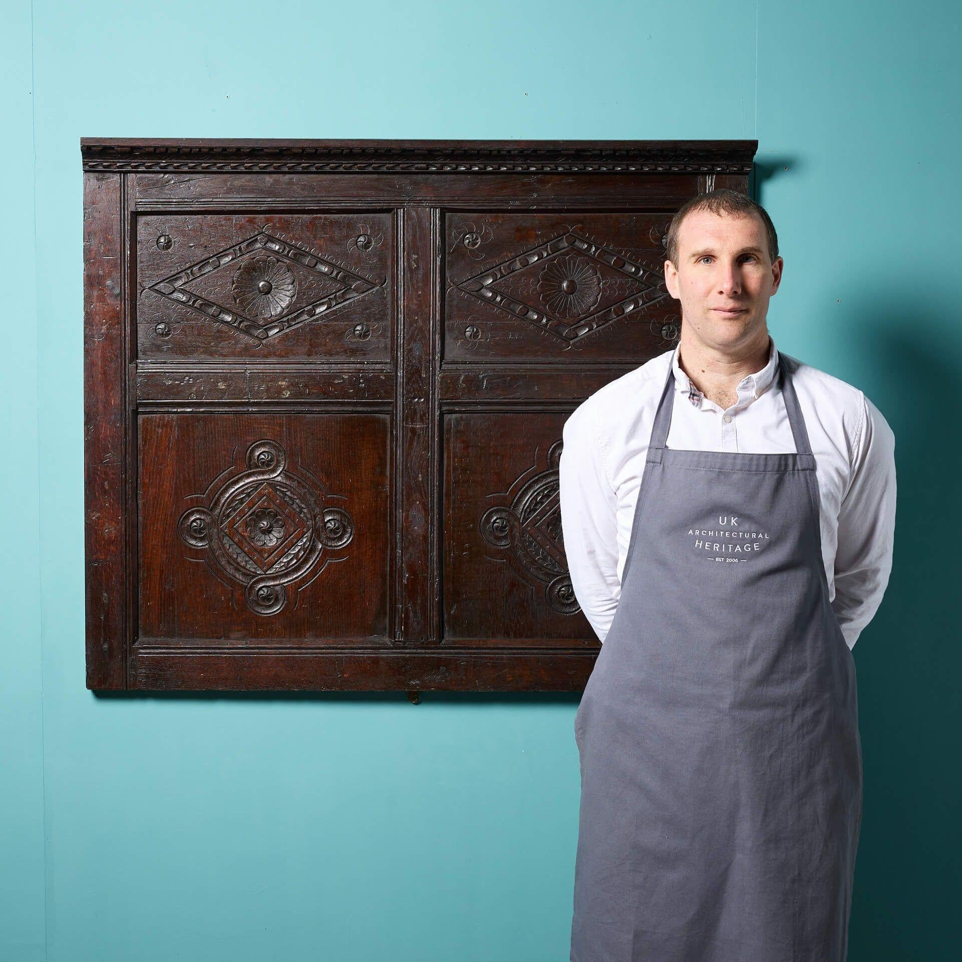 A reclaimed mid 17th century decorative wall hanging panel with a beautiful dark oak patina.

A piece of English history for your home, it features four panels with ornate handcarved geometric details centring around flowers and embellished with