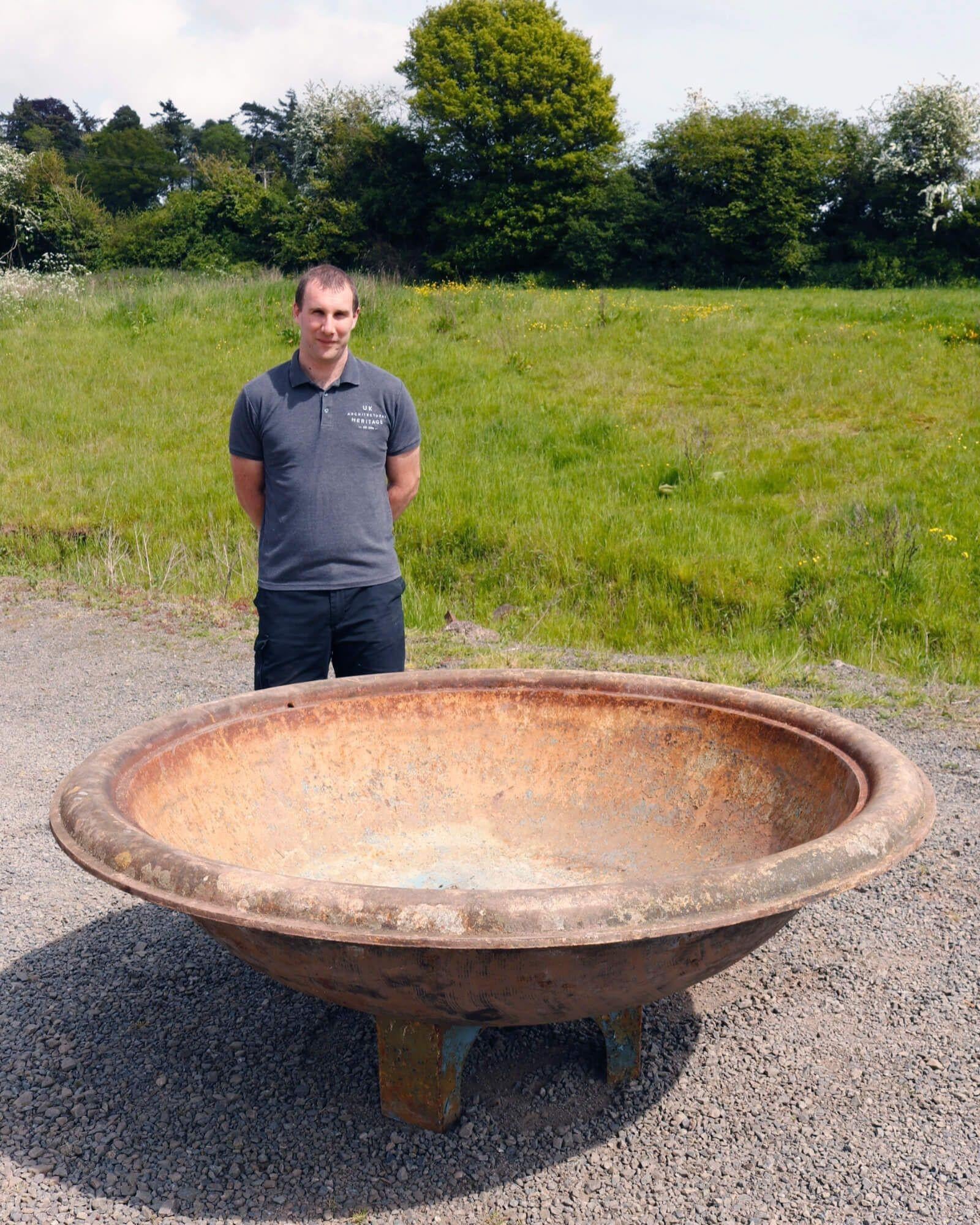 This large cast iron bowl water feature or reclaimed fountain makes a striking centrepiece in gardens traditional and contemporary. Dating from the late 19th century, it is elevated by a triform cast iron base and spans an impressive 1.8m diameter!