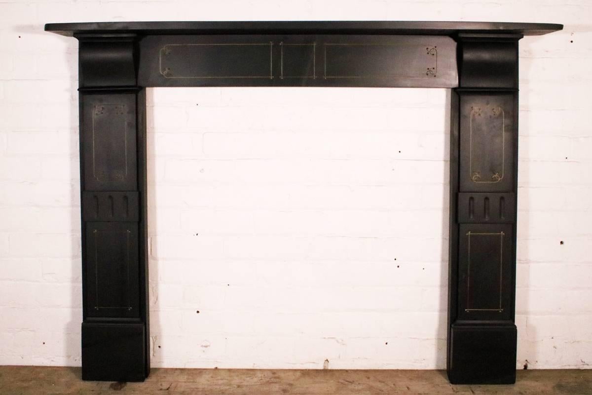 Antique 19th century Victorian slate fireplace surround, with etched detail highlighted in gold and simple shallow corbels supporting the shelf, circa 1890.

It has been finished with a high quality oil to bring out the natural colors in the