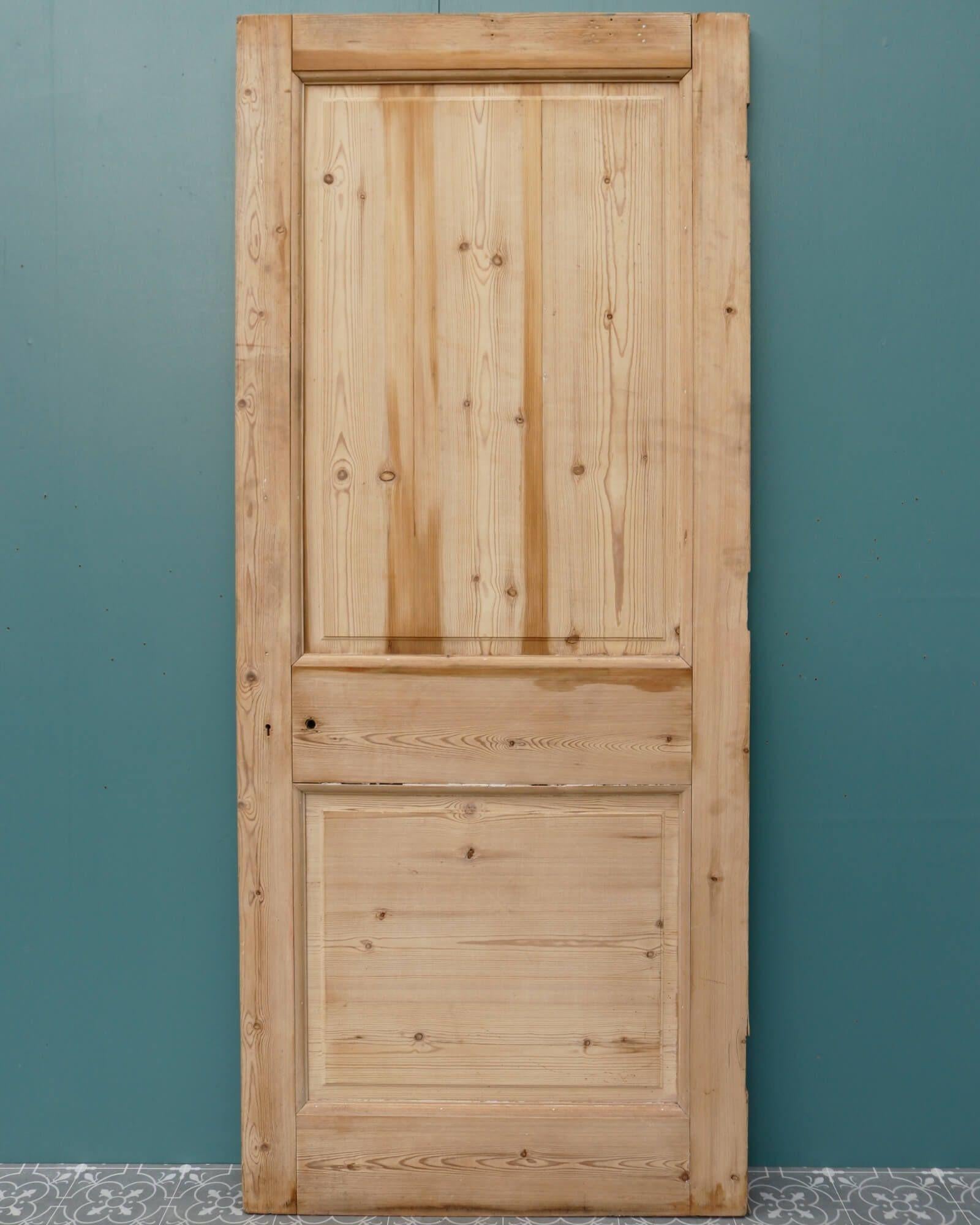 A smart antique 2-panel English pine door for internal use dating from the early 20th century. Made in pine, this Victorian style door features raised and fielded panels to one side and plain panels to the other. It is stripped and sanded, ready for