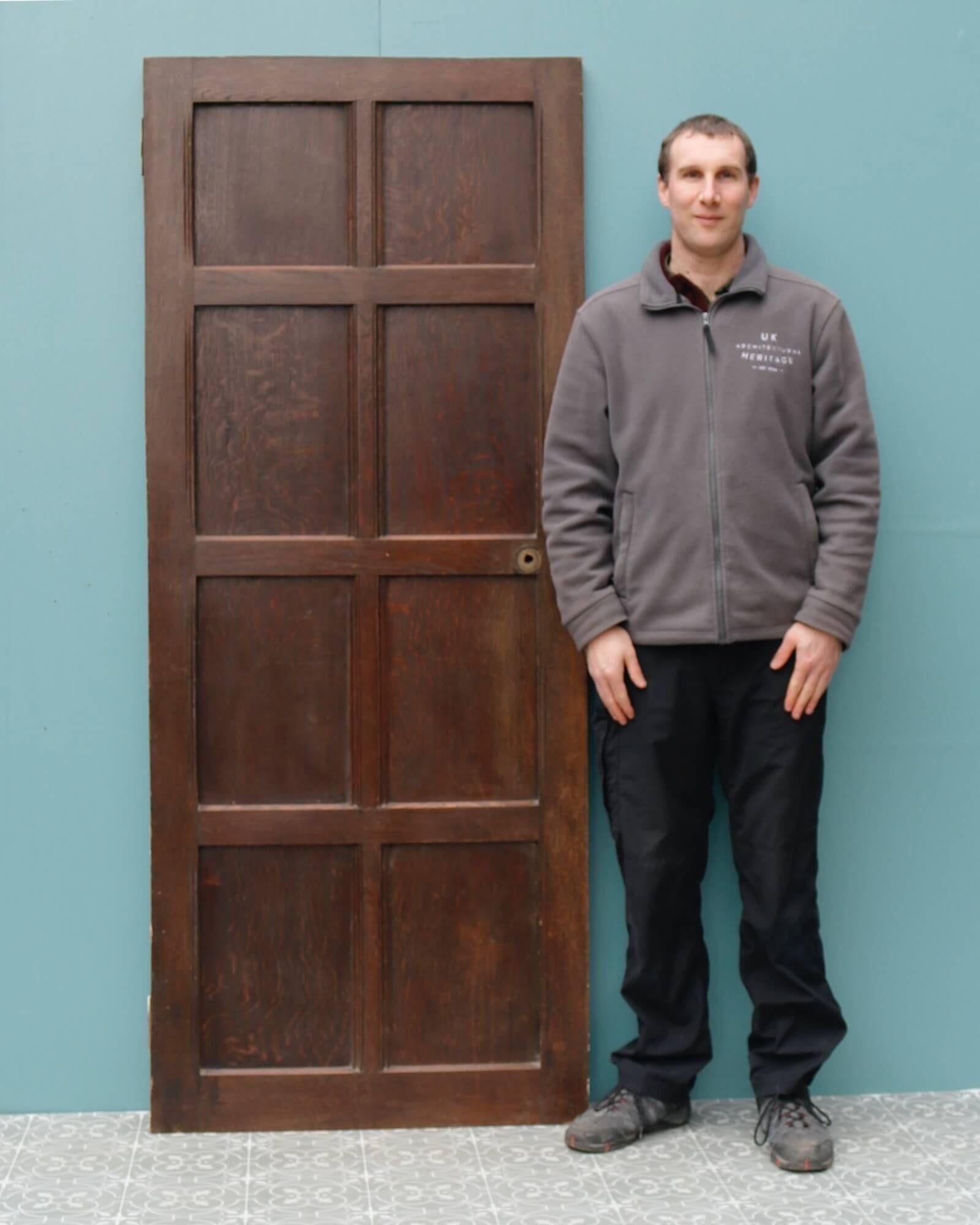 A smart reclaimed Victorian internal door with 8-panels dating from the late 19th century. It features an original oak finish to the front and a painted reverse. With its warm colour and panelled design, this antique door is a handsome addition to a