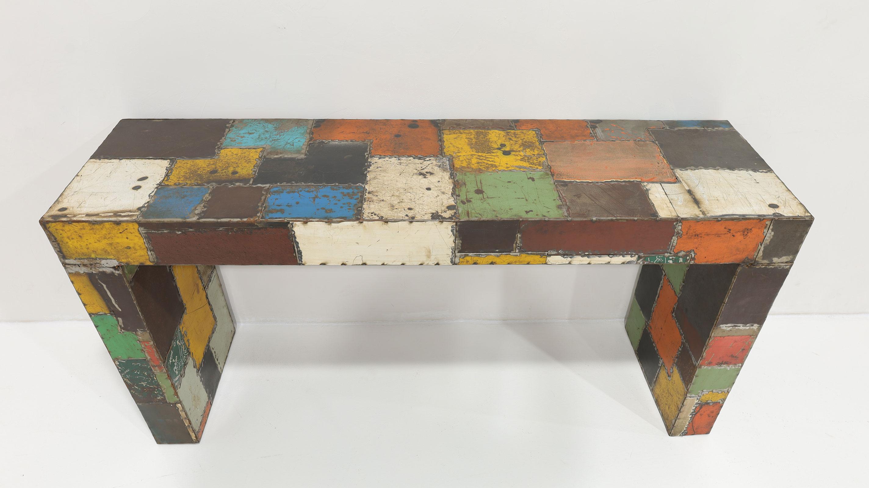 From the private collection of Jim Carrey, this unique console is a Reclaimed Aluminum console patchwork of colorful metal pieces soldered together around a wooden frame. Likely a custom piece by a talented artist, possibly crafted in Mexico, this