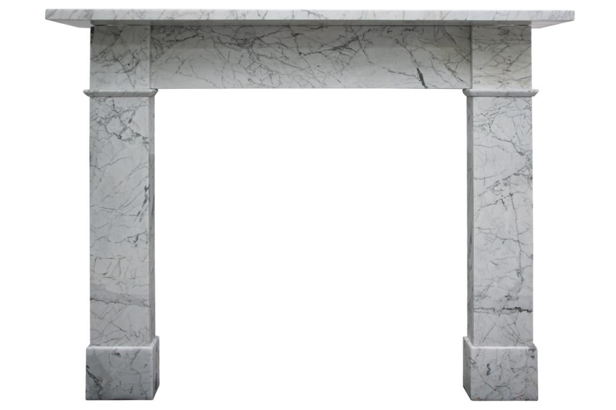 Reclaimed antique 19th century fireplace surround in well figured Carrara marble of simple form, circa 1850. Pictured with an original Victorian cast iron insert, sold separately.