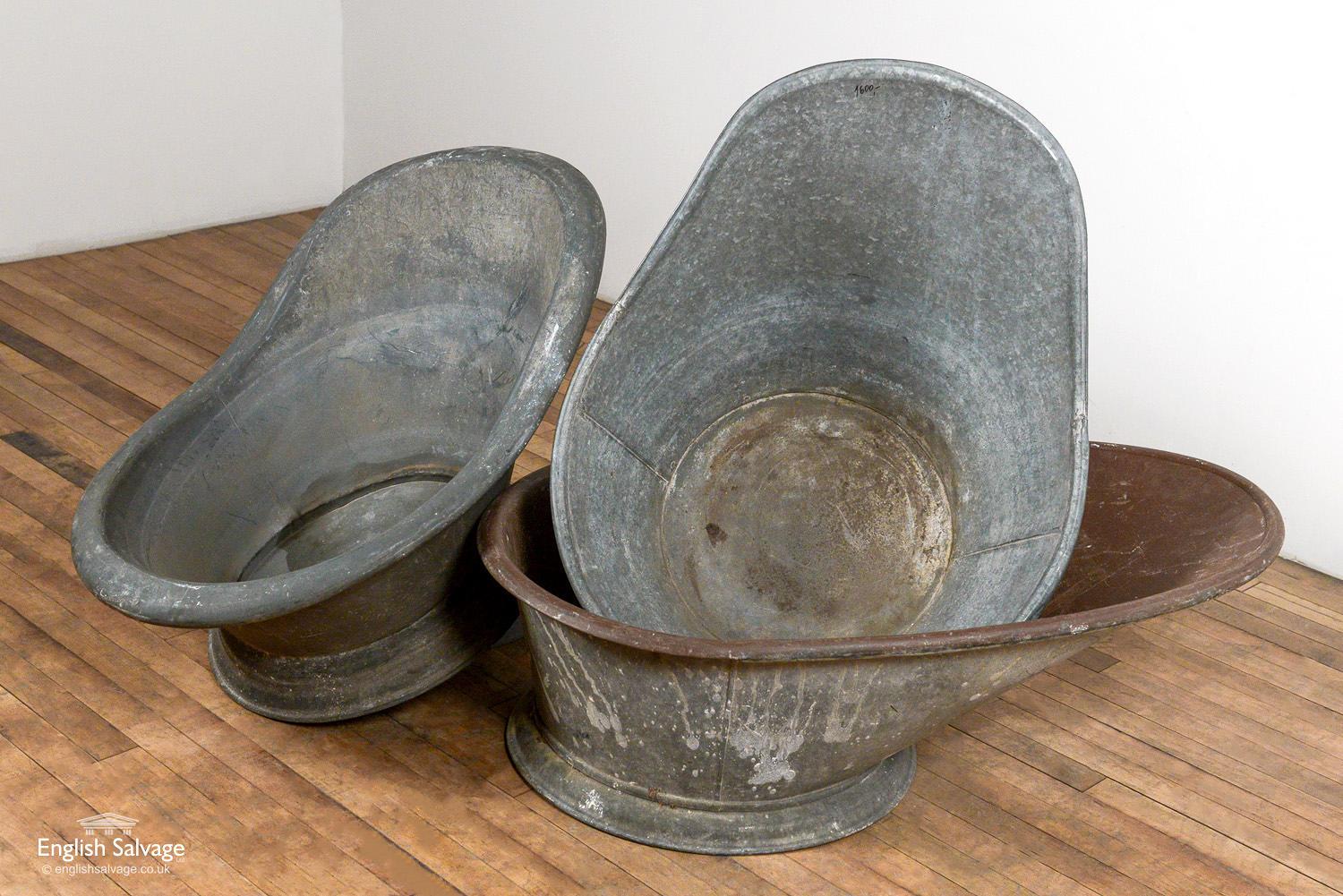 Reclaimed antique hip baths in galvanised metal. One has an interior coating of brown paint. Signs of wear and use, and some scratches and knocks. Measurements below might vary slightly for each of the three baths.