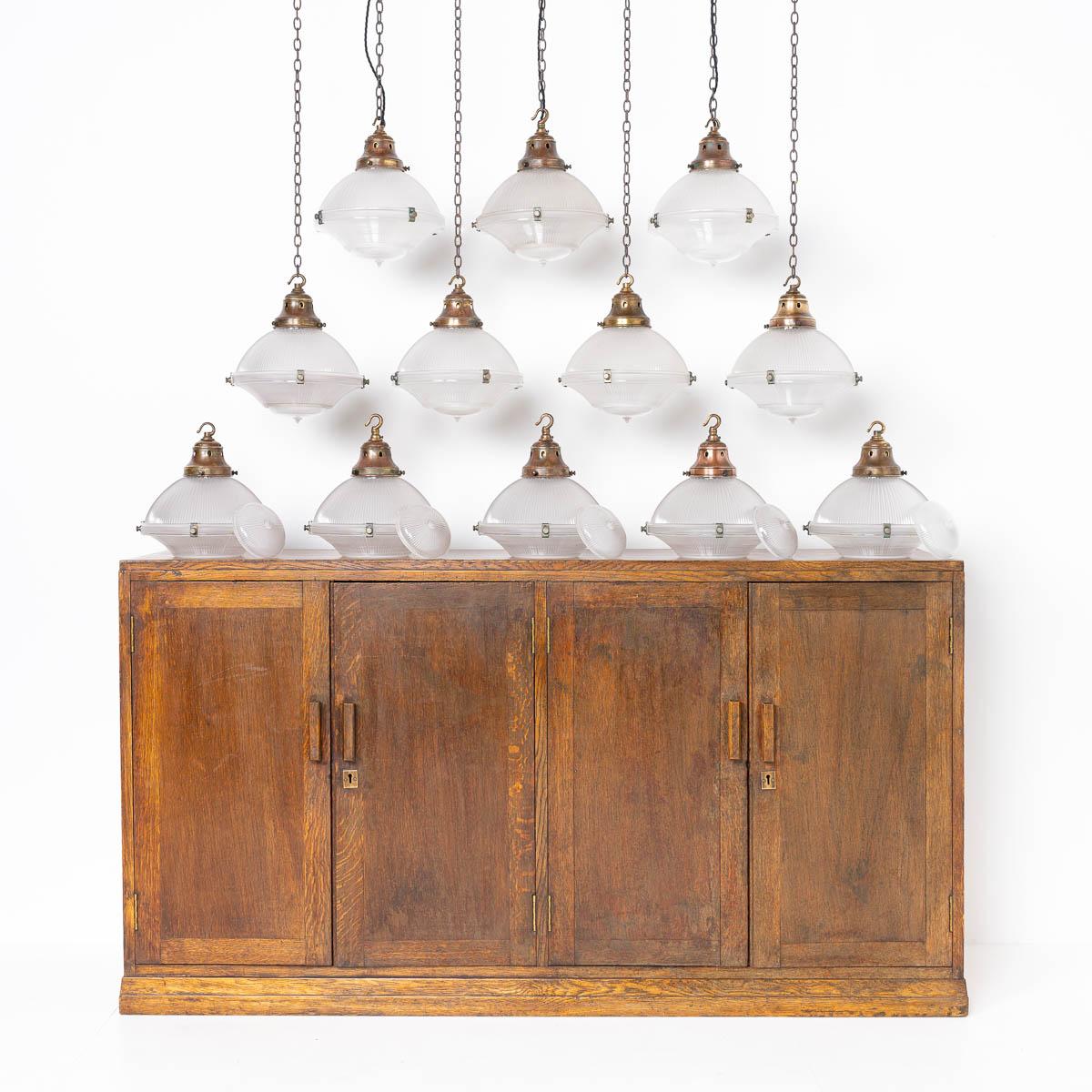 A RARE RUN OF MEDIUM HOLOPHANE THREE PART PENDANT LIGHTS 

PRICE IS PER LIGHT

A stunning run of 12 vintage Holophane pendant lights reclaimed from an abandoned 150 year old chapel originally built in 1876 in the heart of Gwynedd village in