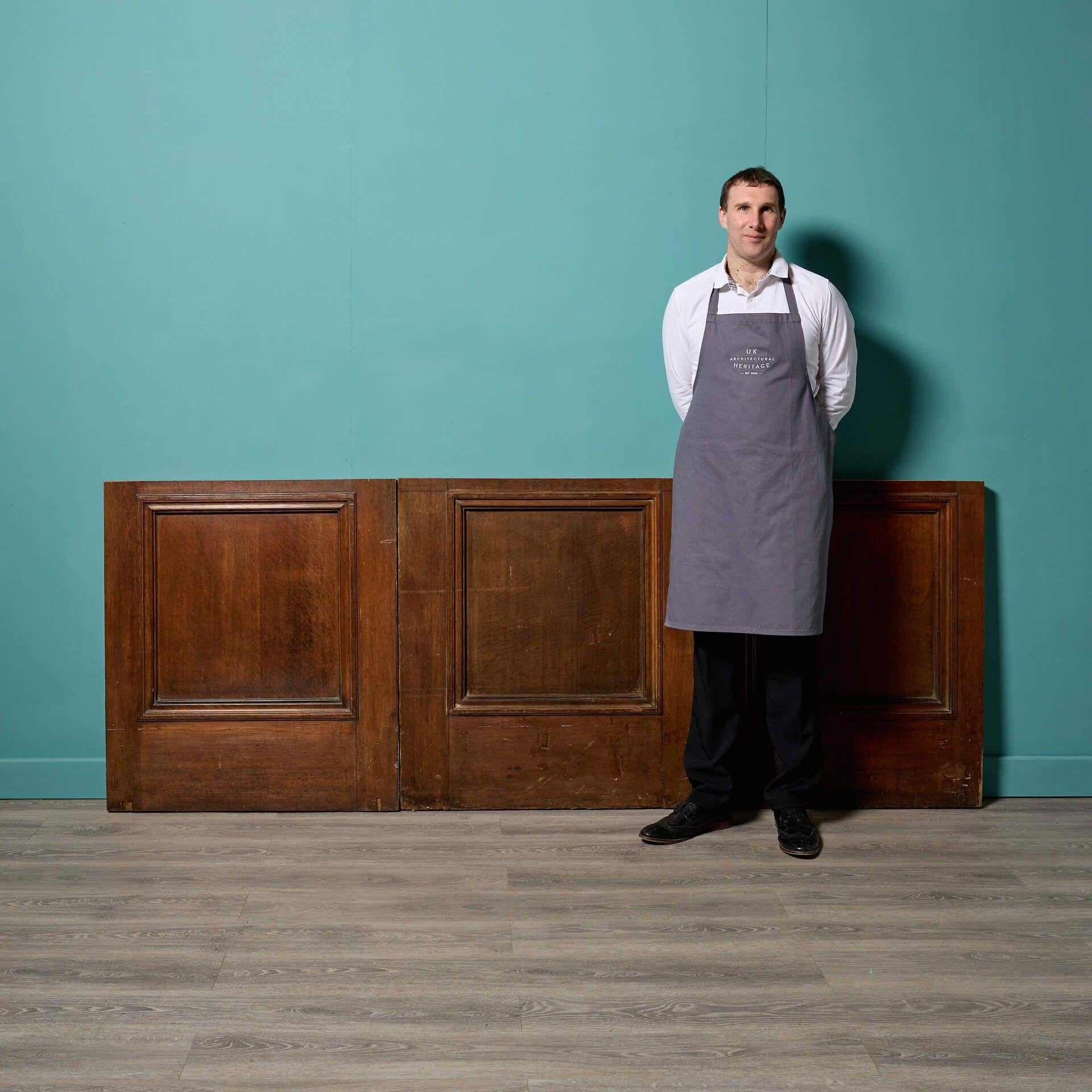 Three early 20th century antique oak panels, usable as a stylish reclaimed bar or counter front. Together these wooden panels span a width of 2.58 m; perfect for creating a large custom-bar for a games room or entertainment space.

Each wooden panel