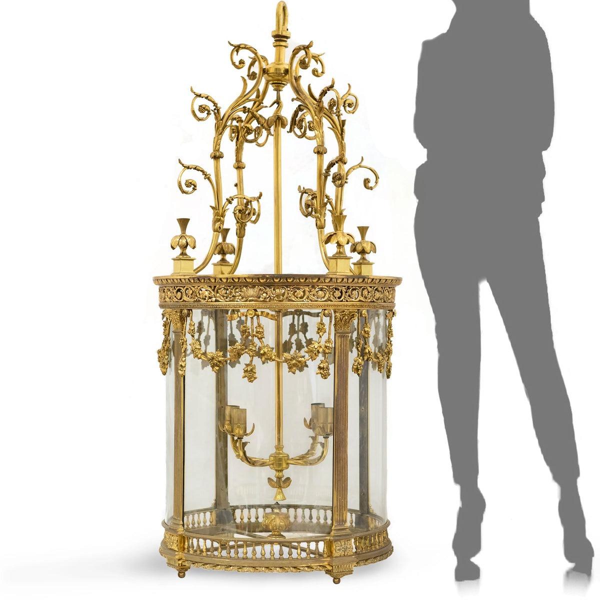 Oozing opulence, this spectacular large, brass lantern has intricate detail throughout featuring delicate florals, acanthus leaf framework and scrolling foliate motifs. 

A centrally suspended candelabra provides four holders.

Encompassed in