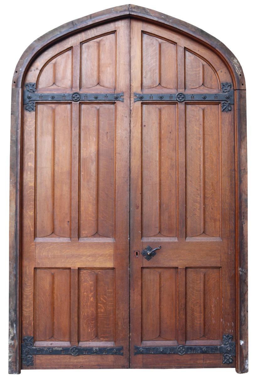 A very substantial set of solid oak doors reclaimed from a former Priory. These antique doors date to around 1887. The doors come with the original hardware pictured. They are carved with double sided linenfold panels. Suitable for exterior or
