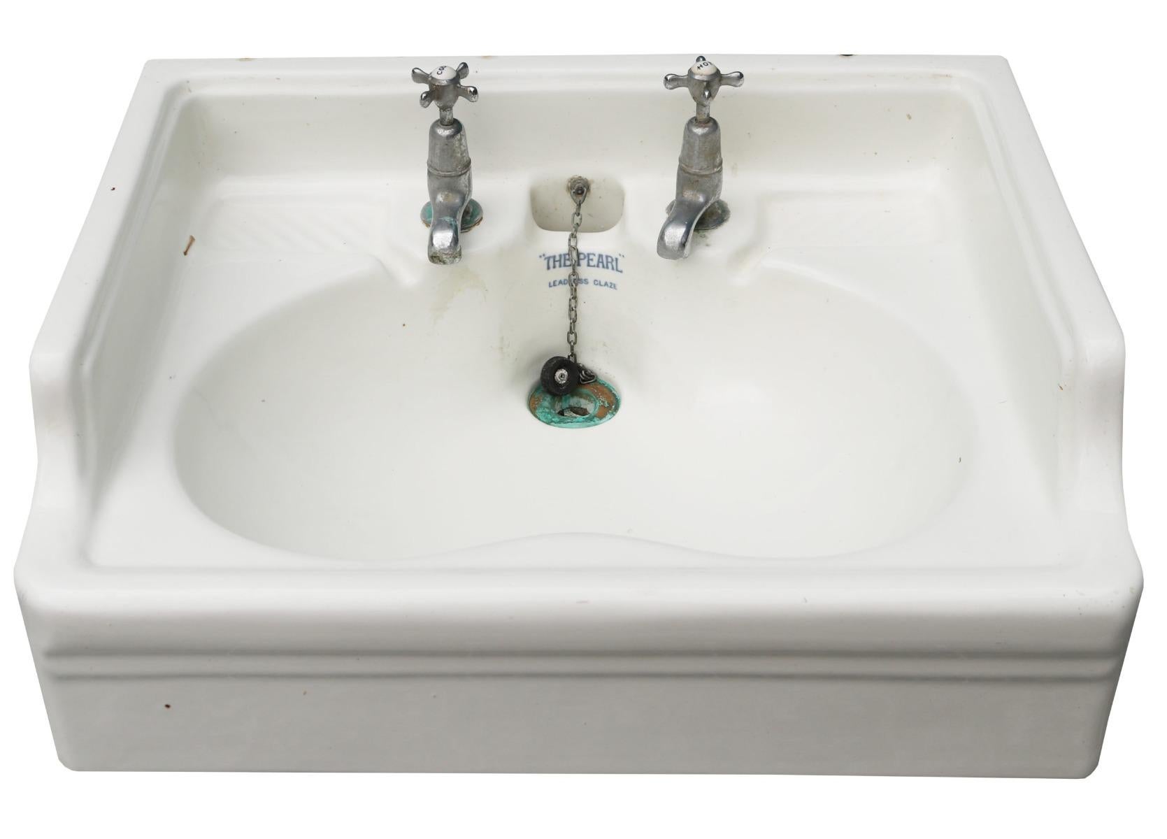 An antique bathroom sink with chrome plated taps, chain, waste and plug. We have three near identical basins available.