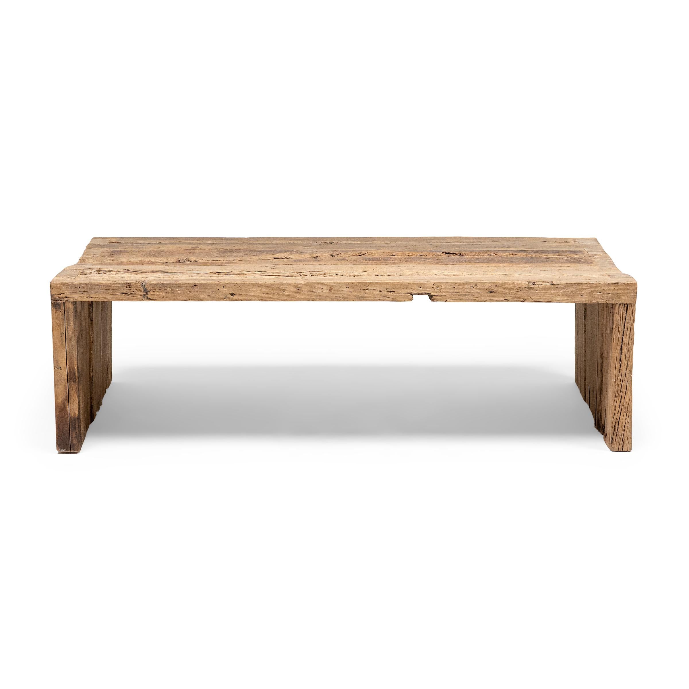 This modern console table is a celebration of wabi-sabi style. Crafted of wood reclaimed from Qing-dynasty architecture, the table has a minimalist waterfall design with dovetailed corners that recreate traditional joinery methods and add intrigue