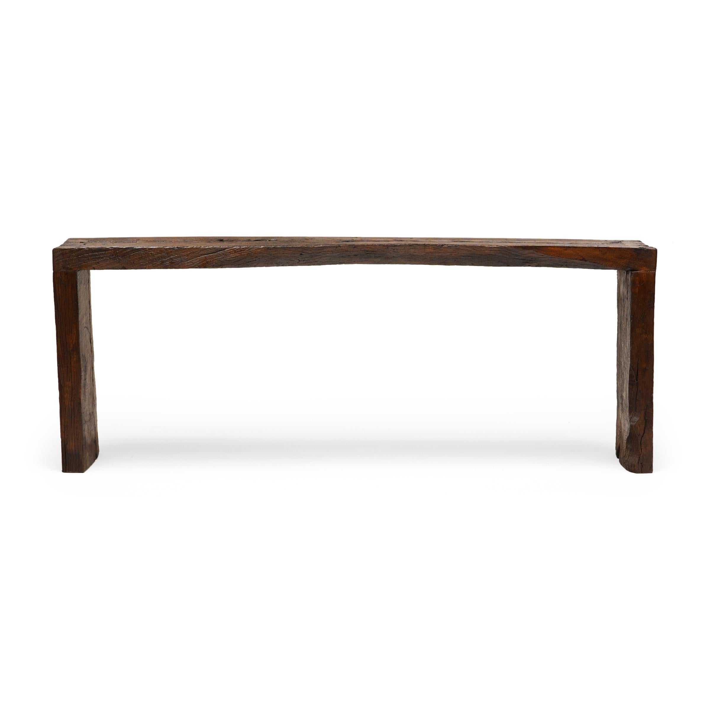 This contemporary console table is a celebration of wabi-sabi style. Crafted of wood reclaimed from Qing-dynasty architecture, the table has a minimalist waterfall design with dovetailed corners that recreate traditional joinery methods. The long