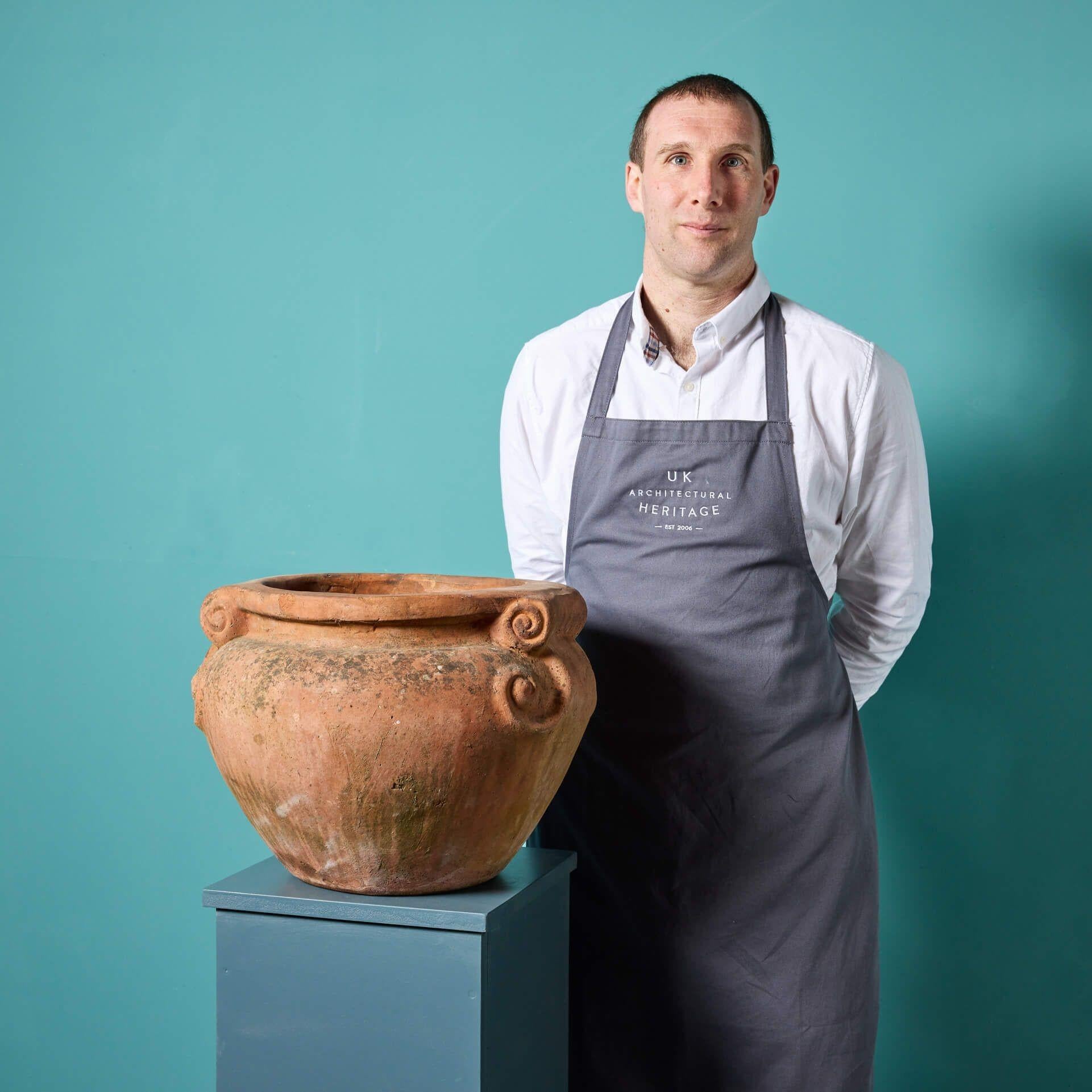 A reclaimed Compton style rich terracotta scroll pot. With its handmade design and natural weathered finish, this reclaimed Compton style scroll pot makes a beautiful feature of a countryside patio or contemporary roof terrace.

Natural weathering