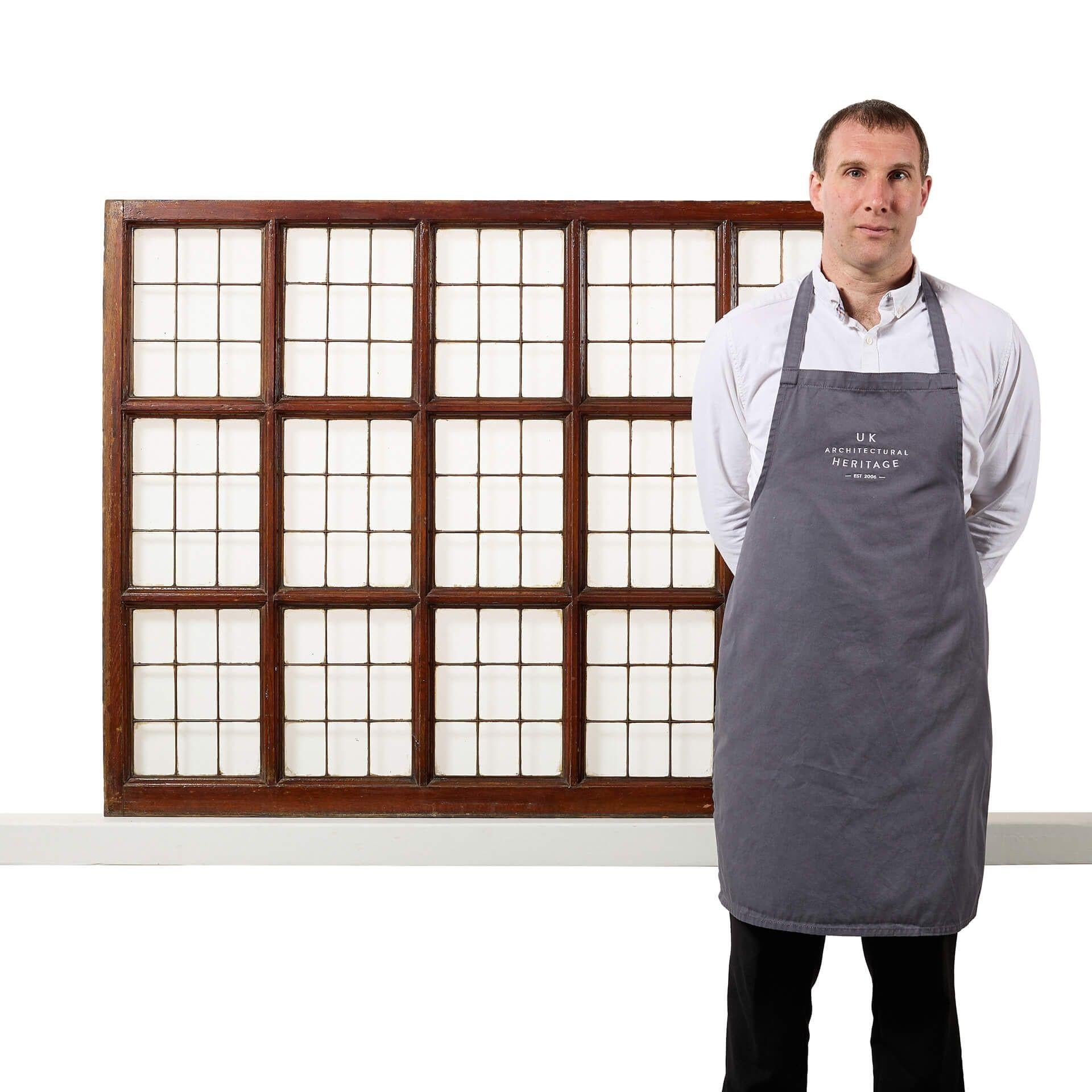 A large early 20th century glazed copperlight window panel with teak frame and 15 copperlight panels. Though this reclaimed window is an original of the 1920s era, it will make a stylish feature window in a 21st century home with its fine