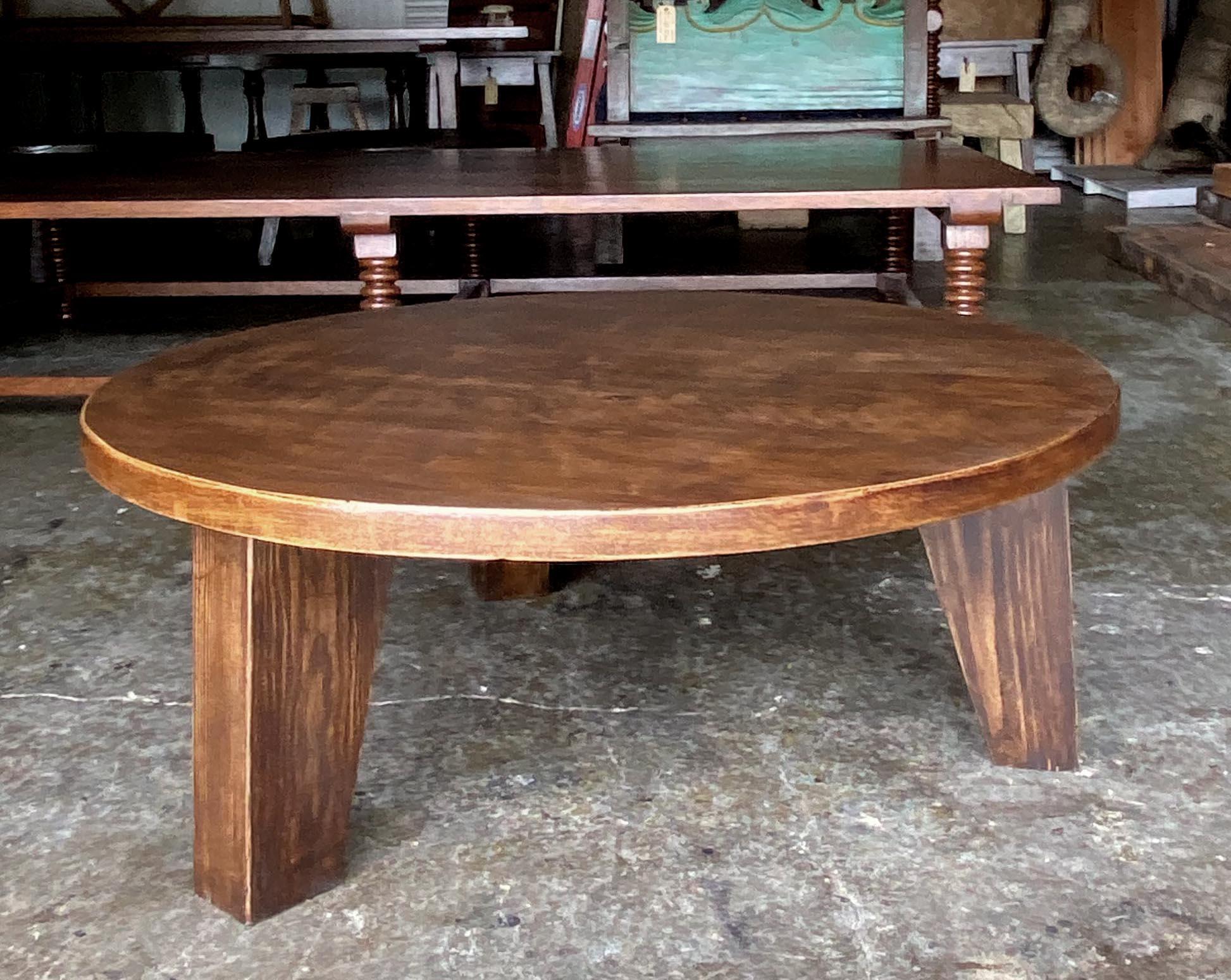 Coffee table with three tapered legs made from reclaimed cypress wood. Sturdy construction. Two inch thick top.