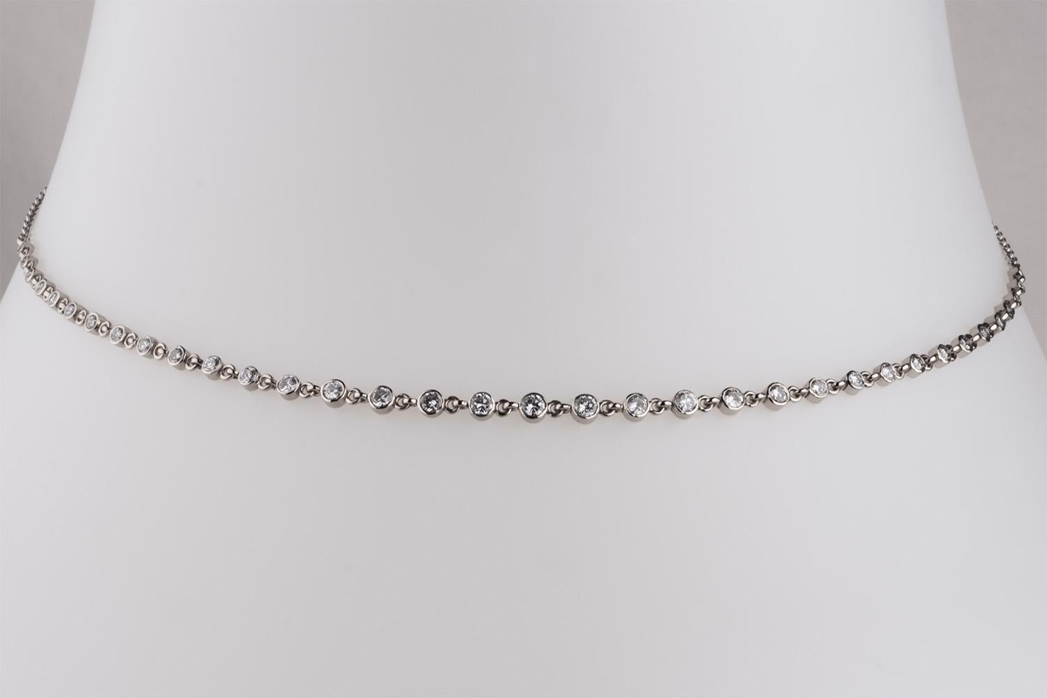 Reclaimed diamonds bezel set in 14 karat white gold creates a sparkly necklace that simply goes with everything.
Featuring 1.35 carats of diamonds that graduate in size as they move towards the centre of the chain. 
Designed to fit near your