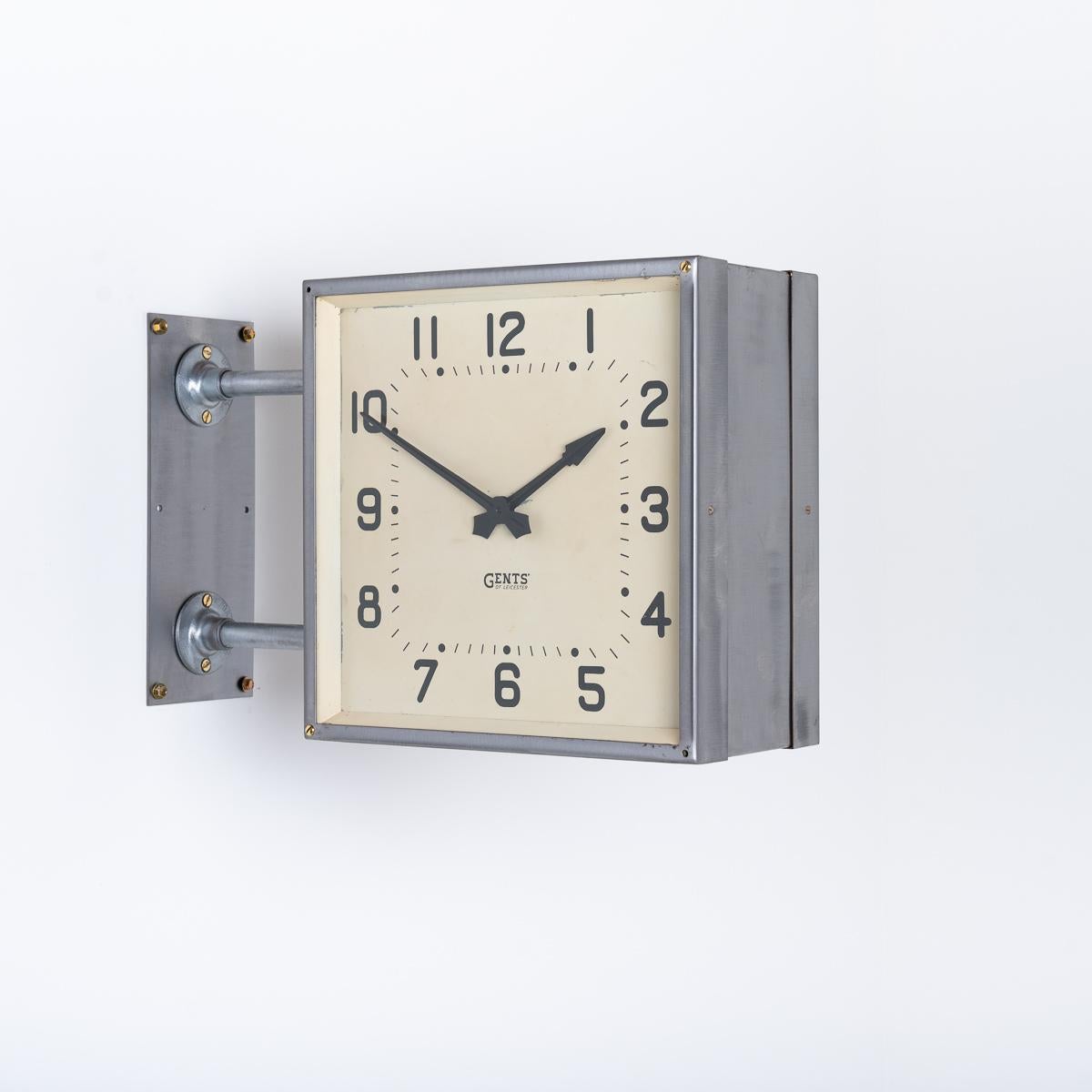 DOUBLE SIDED SQUARE WALL CLOCK BY GENTS OF LEICESTER

A rare form and size clock by British clock makers Gents of Leicester.

Manufactured circa 1940

The clocks steel case has been exposed and left in a RAW brushed finish and protected with a
