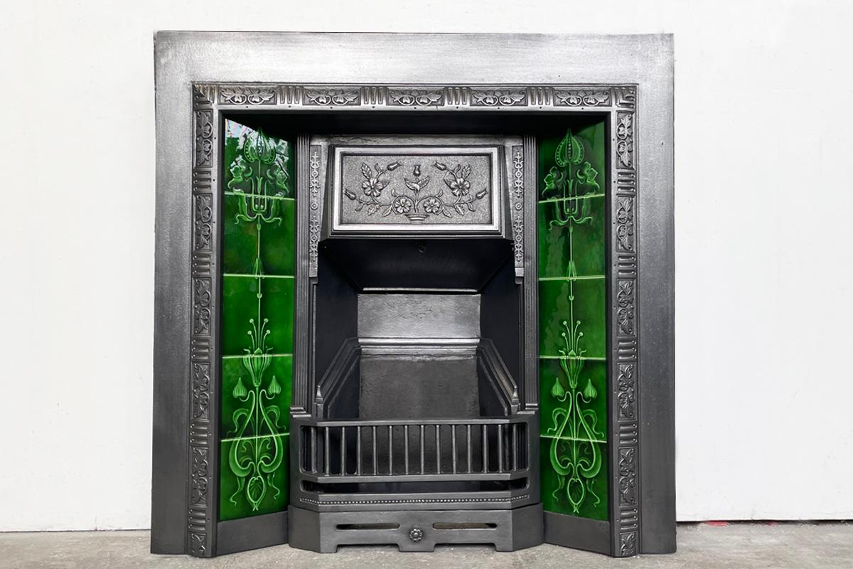Reclaimed Edwardian cast iron and tiled fireplace grate. Circa 1905. Complete with an original set of green Art Nouveau antique fireplace tiles.

The cast iron has been finished with traditional black grate polish.

For detailed sizes see the size