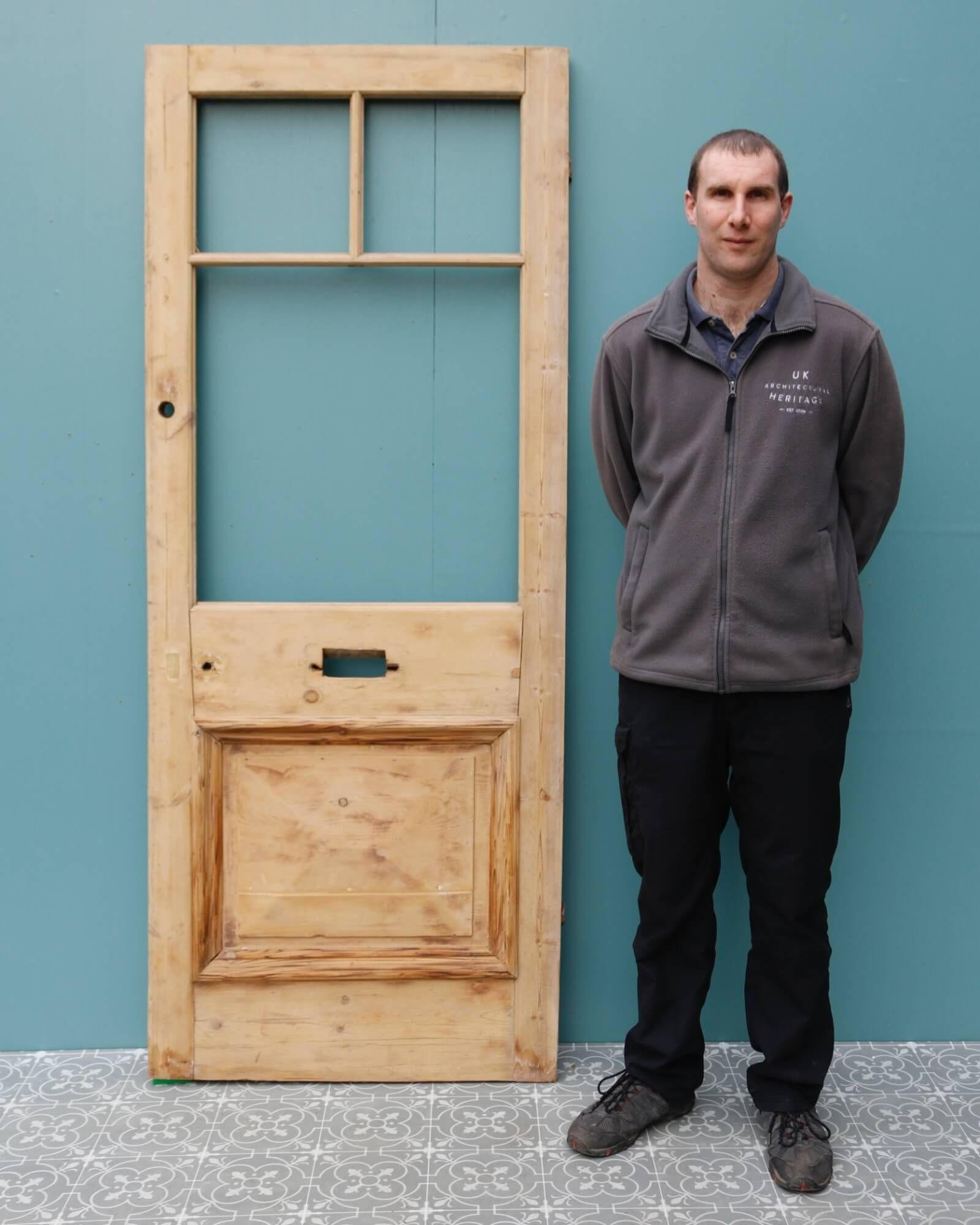 A smart unglazed reclaimed Edwardian pine front door circa 1890, perfect for the entrance of a Victorian era townhouse or period property. Made in sturdy pine, this antique door features 3 panels for glazing above a raised pyramid panel to the front