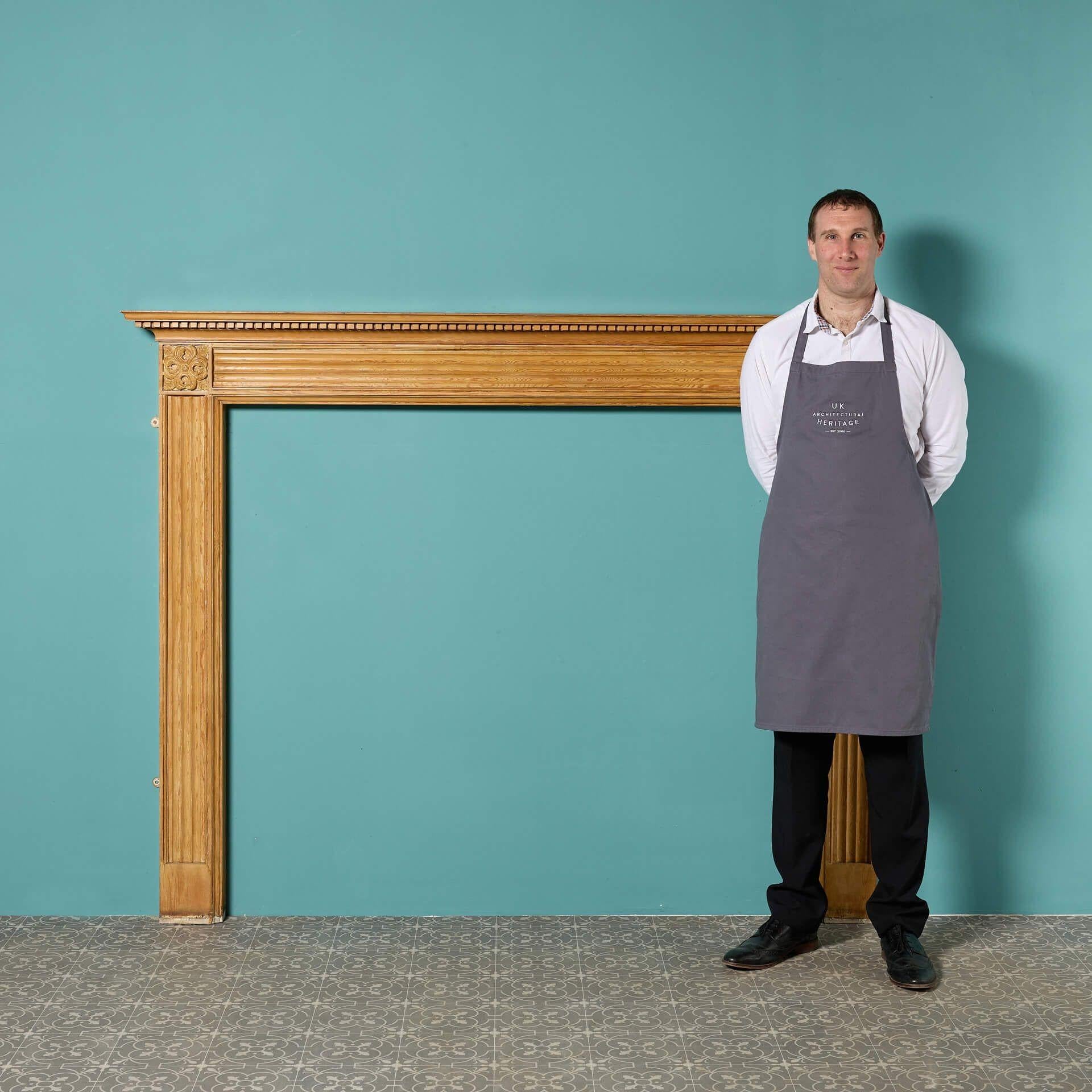 A handsome reclaimed Edwardian style fire surround. Constructed in pine, its light, varnished finish and simple design makes this fireplace a timeless piece for interiors old and new. Decorative elements include a row of dentils below the mantel and